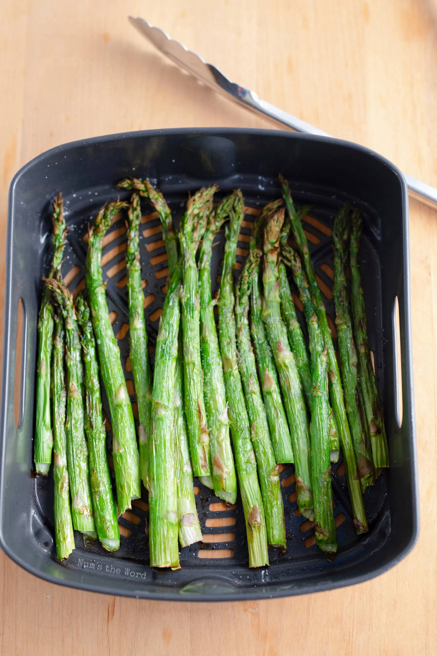 Asparagus in air fryer, cooked.