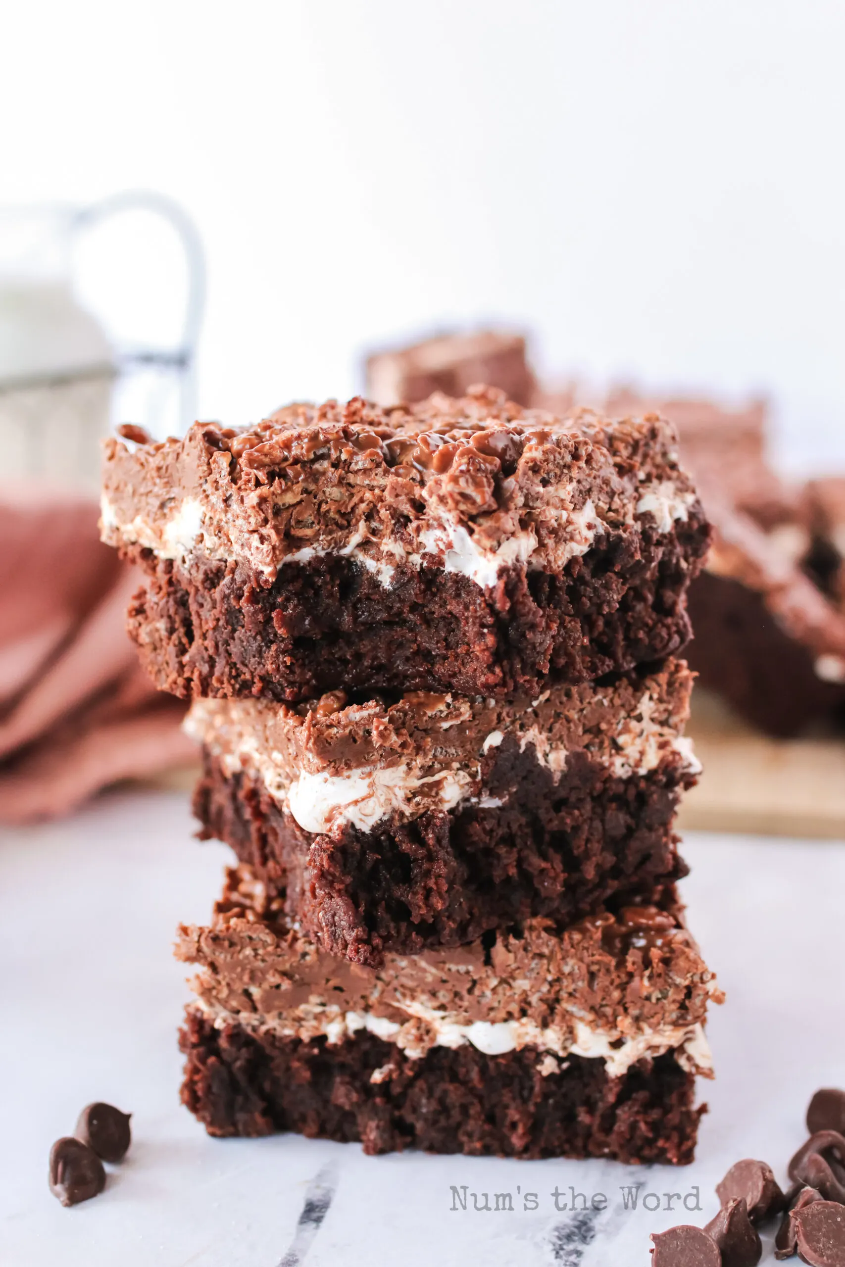 bite removed from the top brownie of 3 stacked brownies.