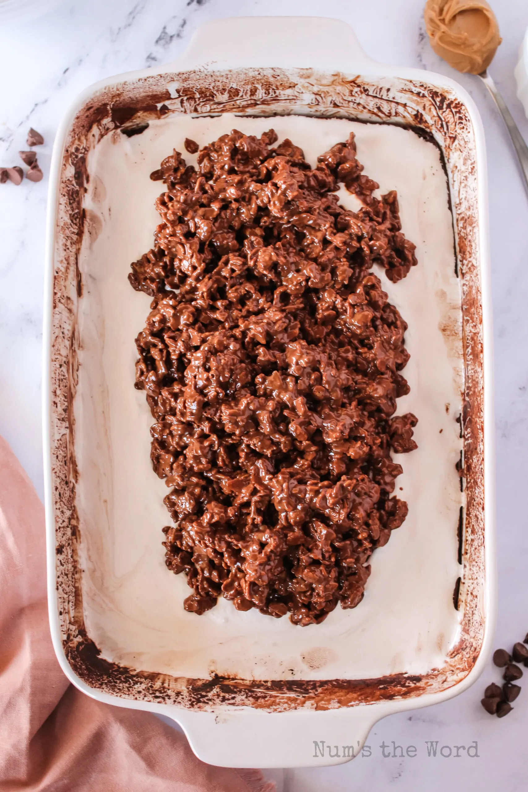 peanut butter rice krispie mix placed on top of marshmallow creme.