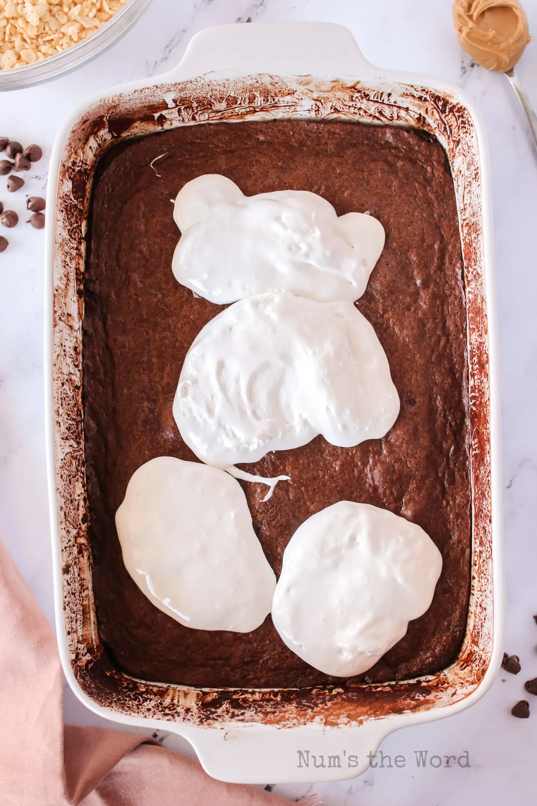 Marshmallow cream poured over warm brownies.