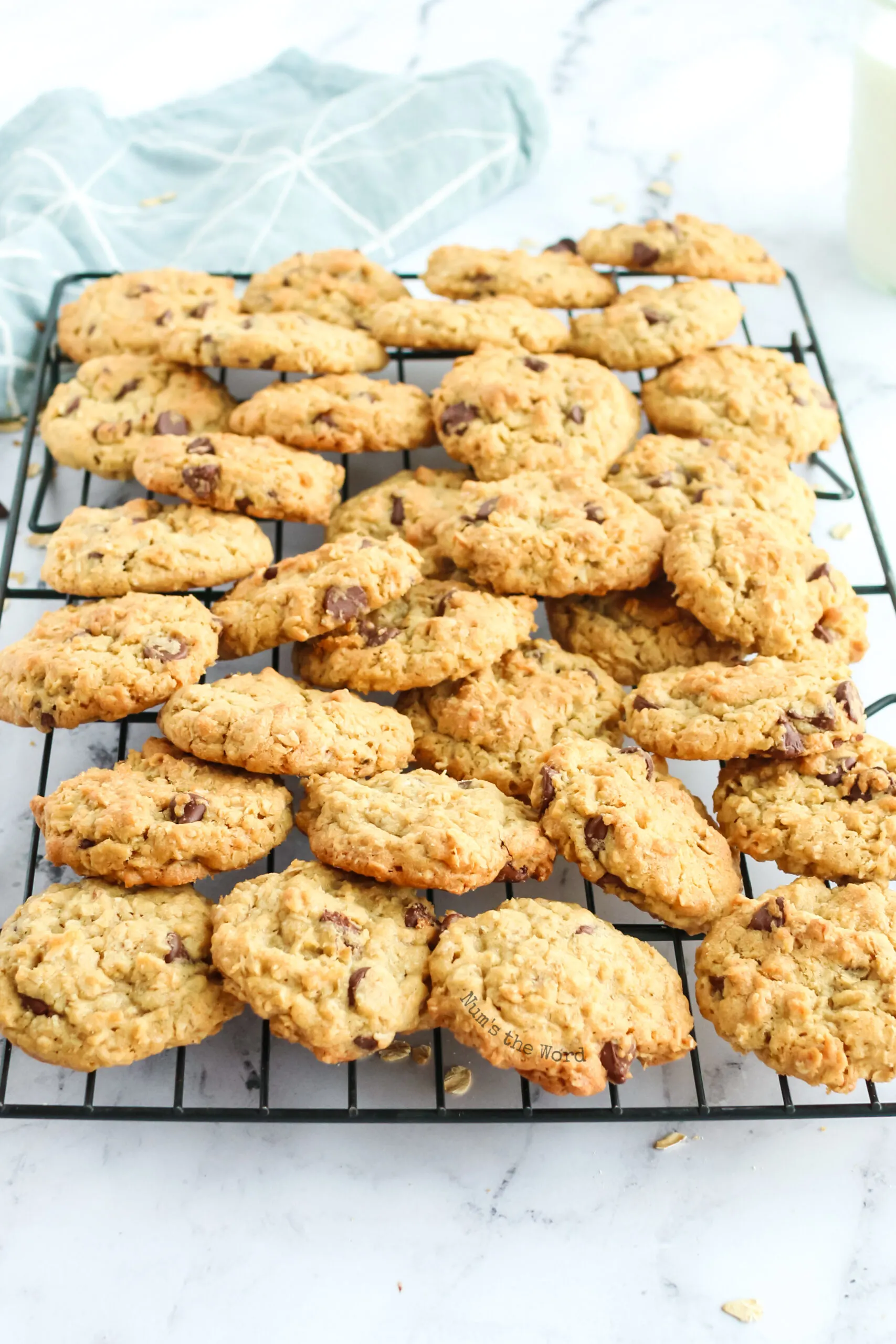 zoomed out image of a pile of cookies on a cooling rack.