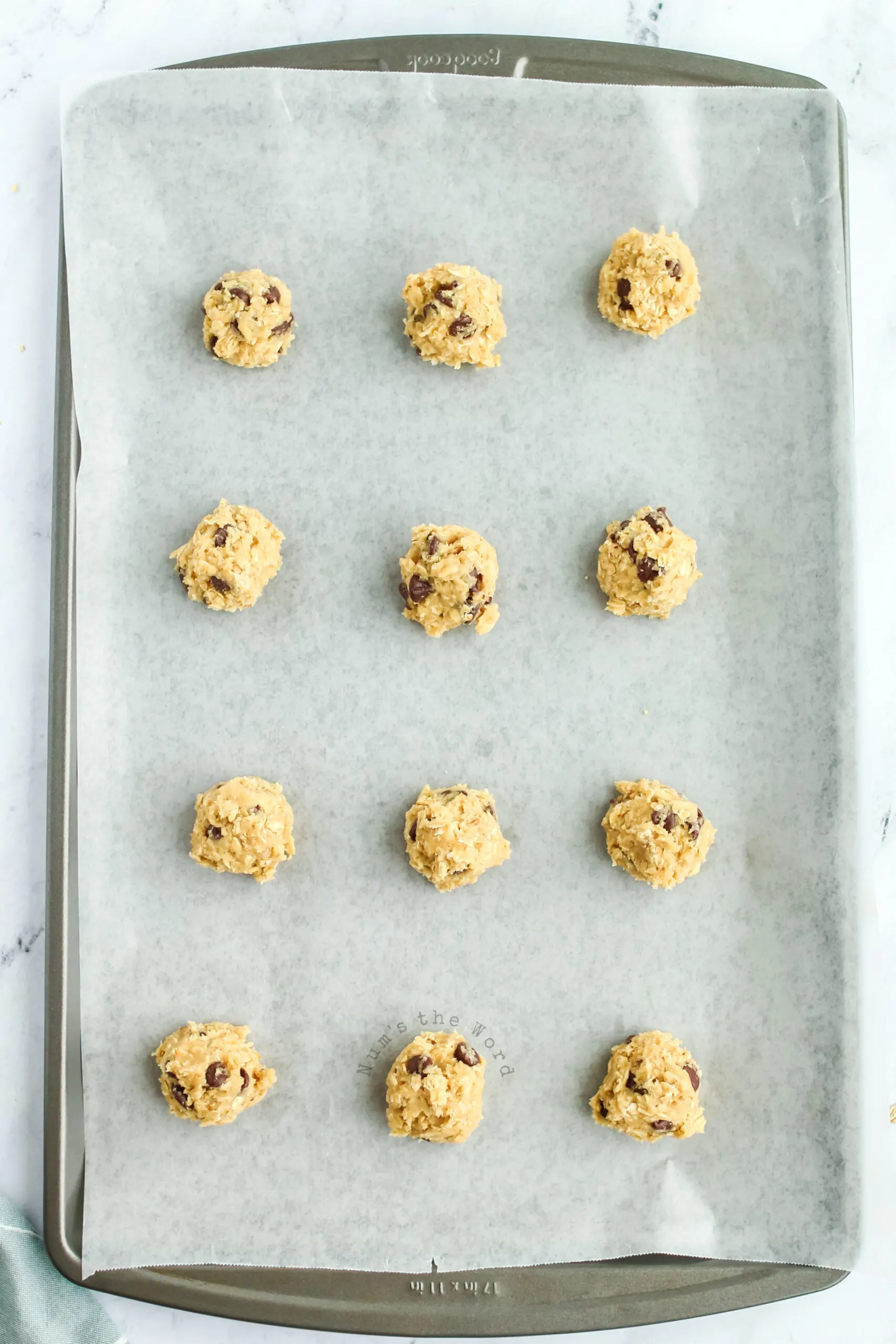 cookie dough balls on a cookie sheet ready to go into the oven.