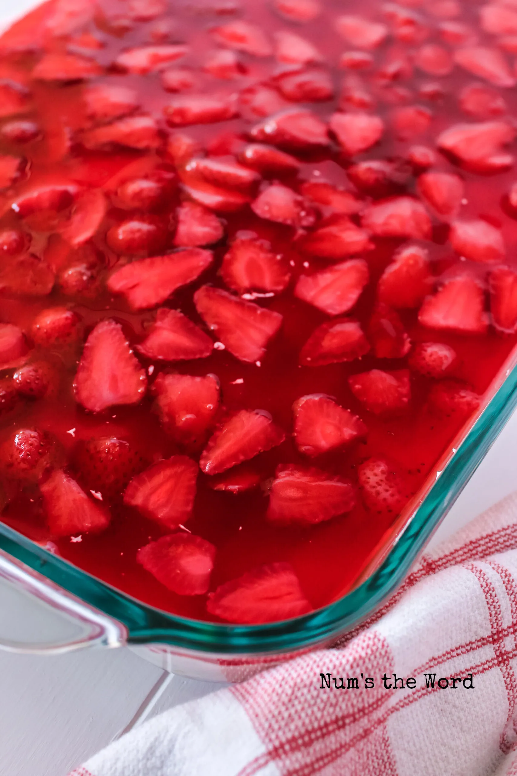 close up of top of jello to show off the strawberry inside.