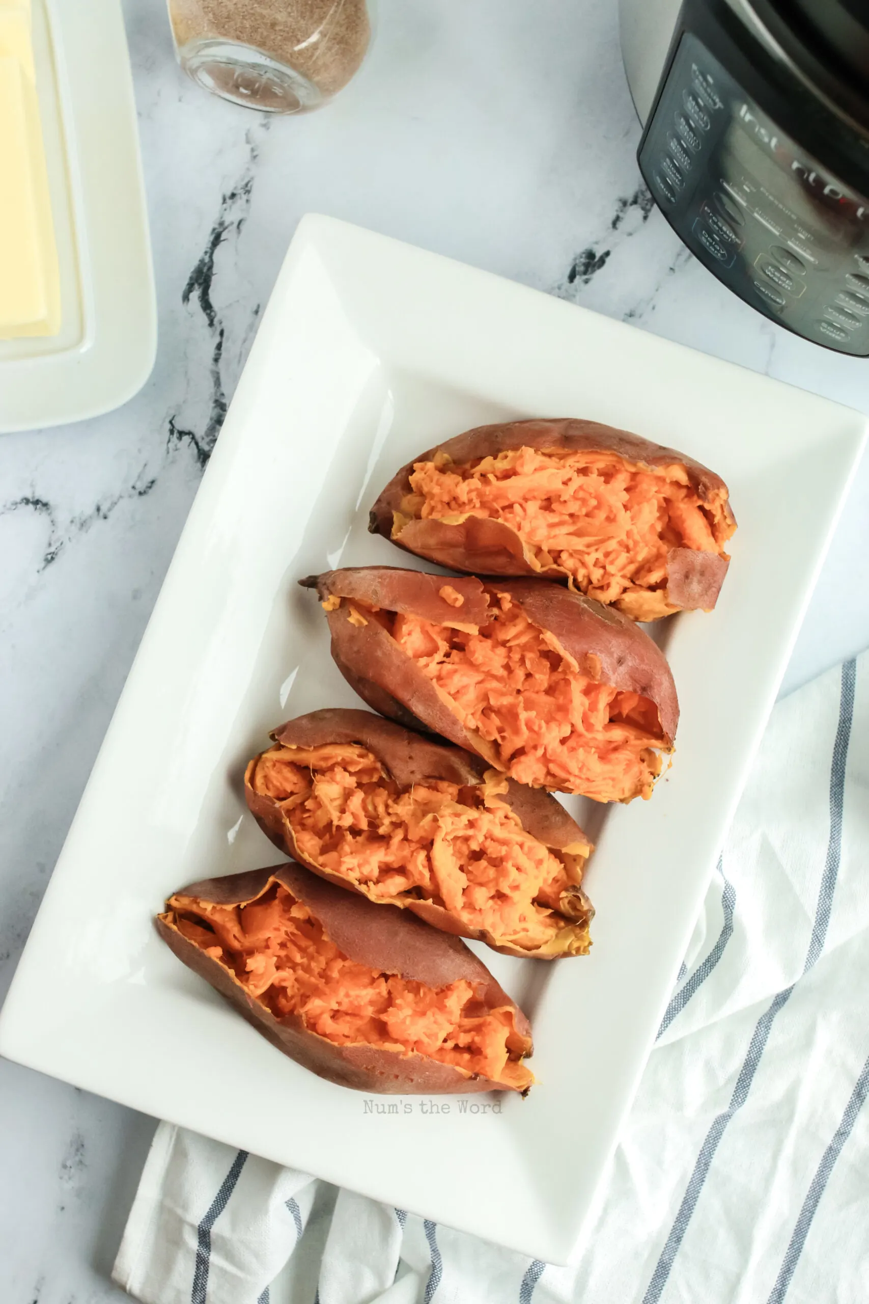 4 sweet potatoes on a platter with cinnamon sugar