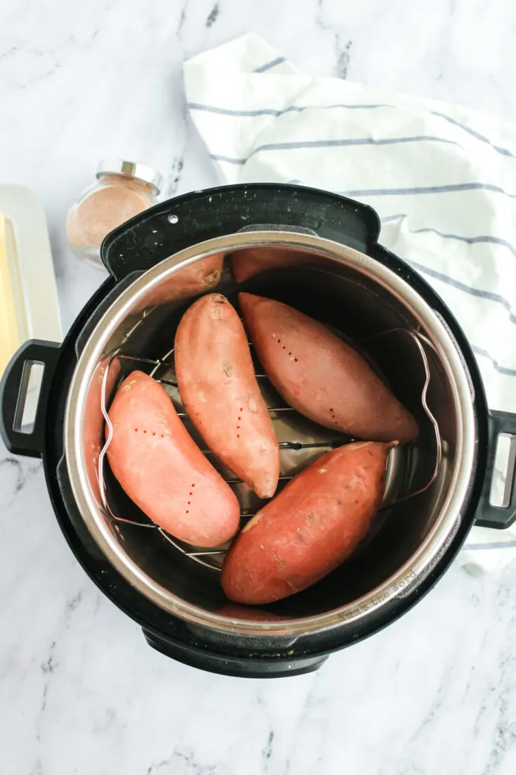 4 sweet potatoes in the instant pot, ready to cook.