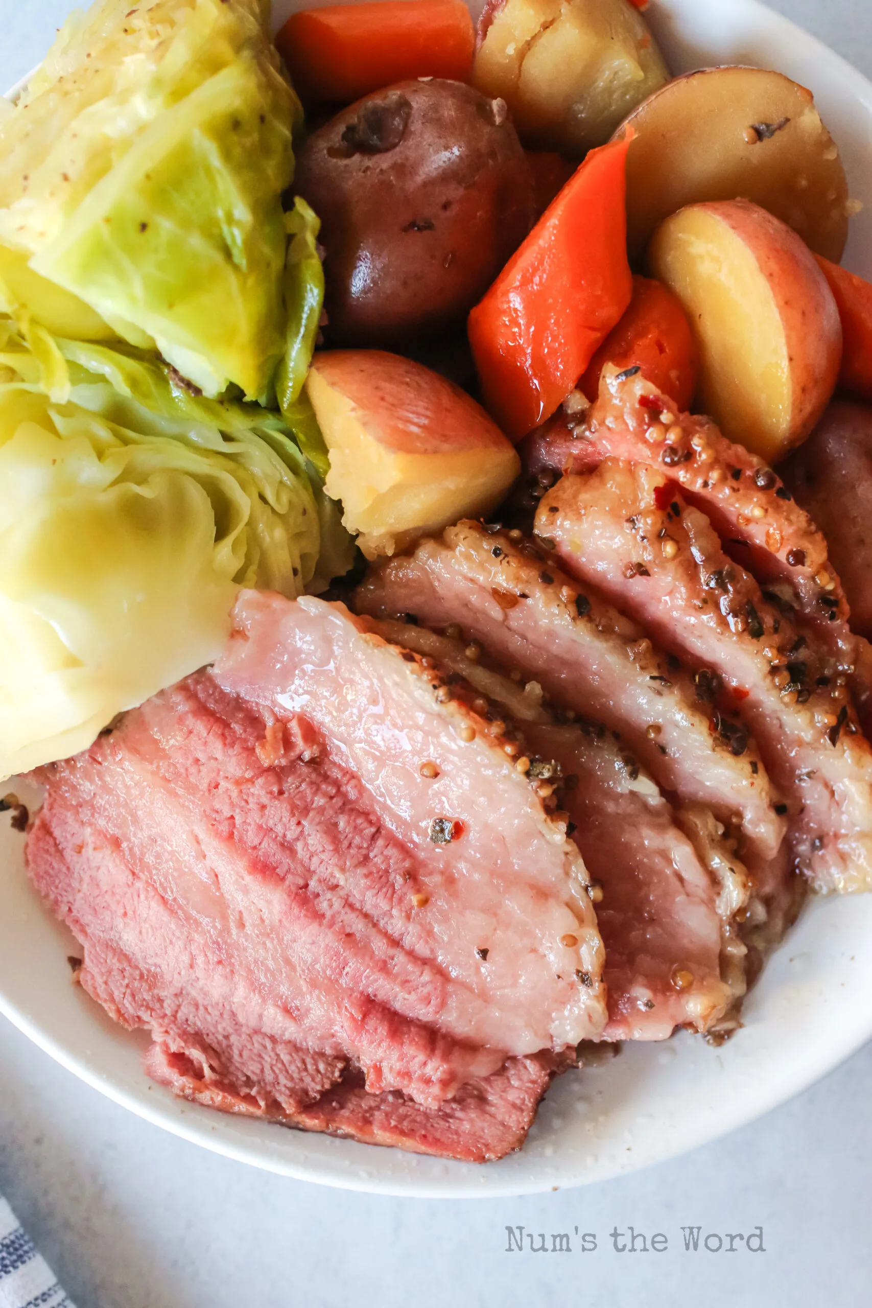 slices of corned beef on a platter with veggies