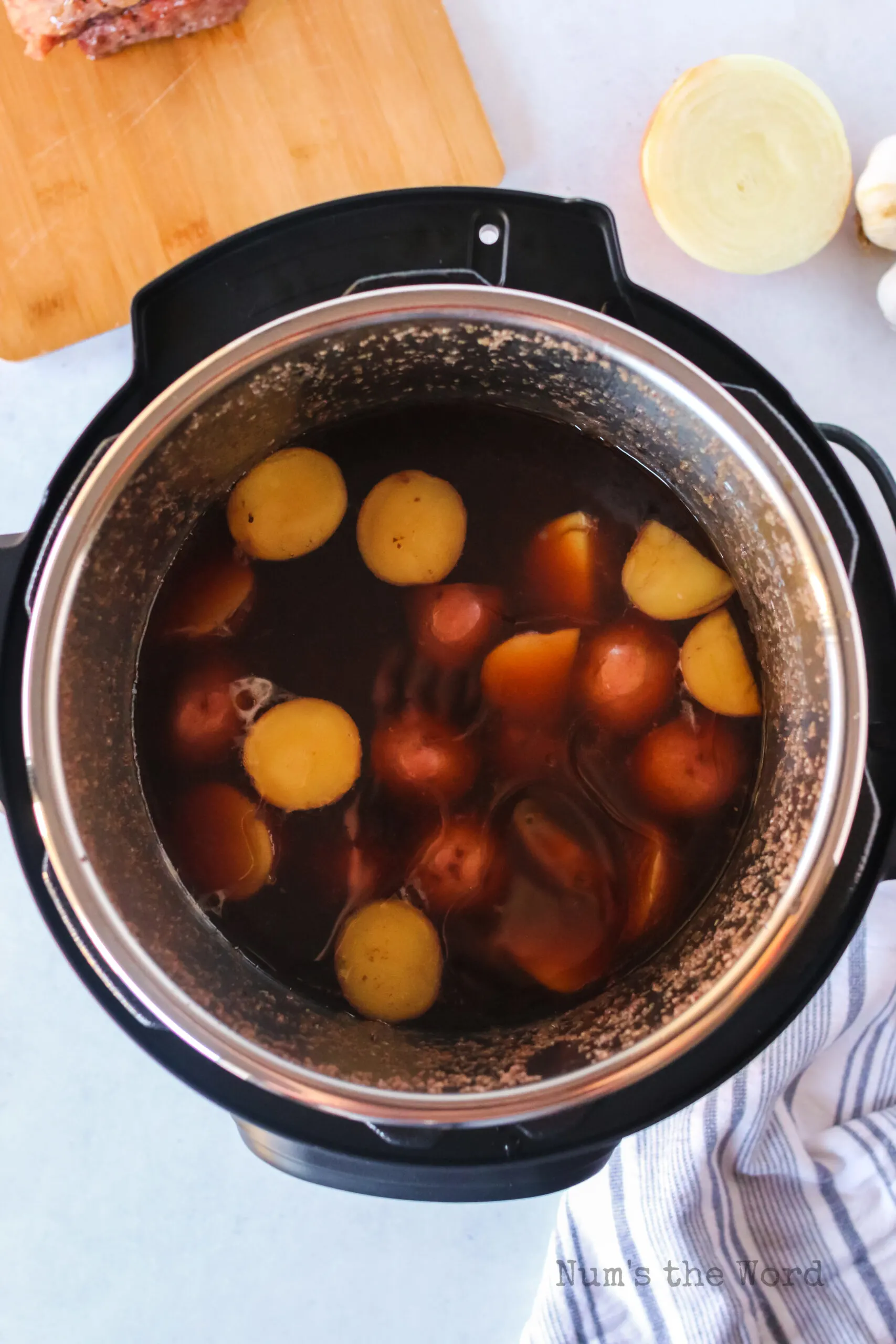 onions and corned beef removed from instant pot. Potatoes added to instant pot.