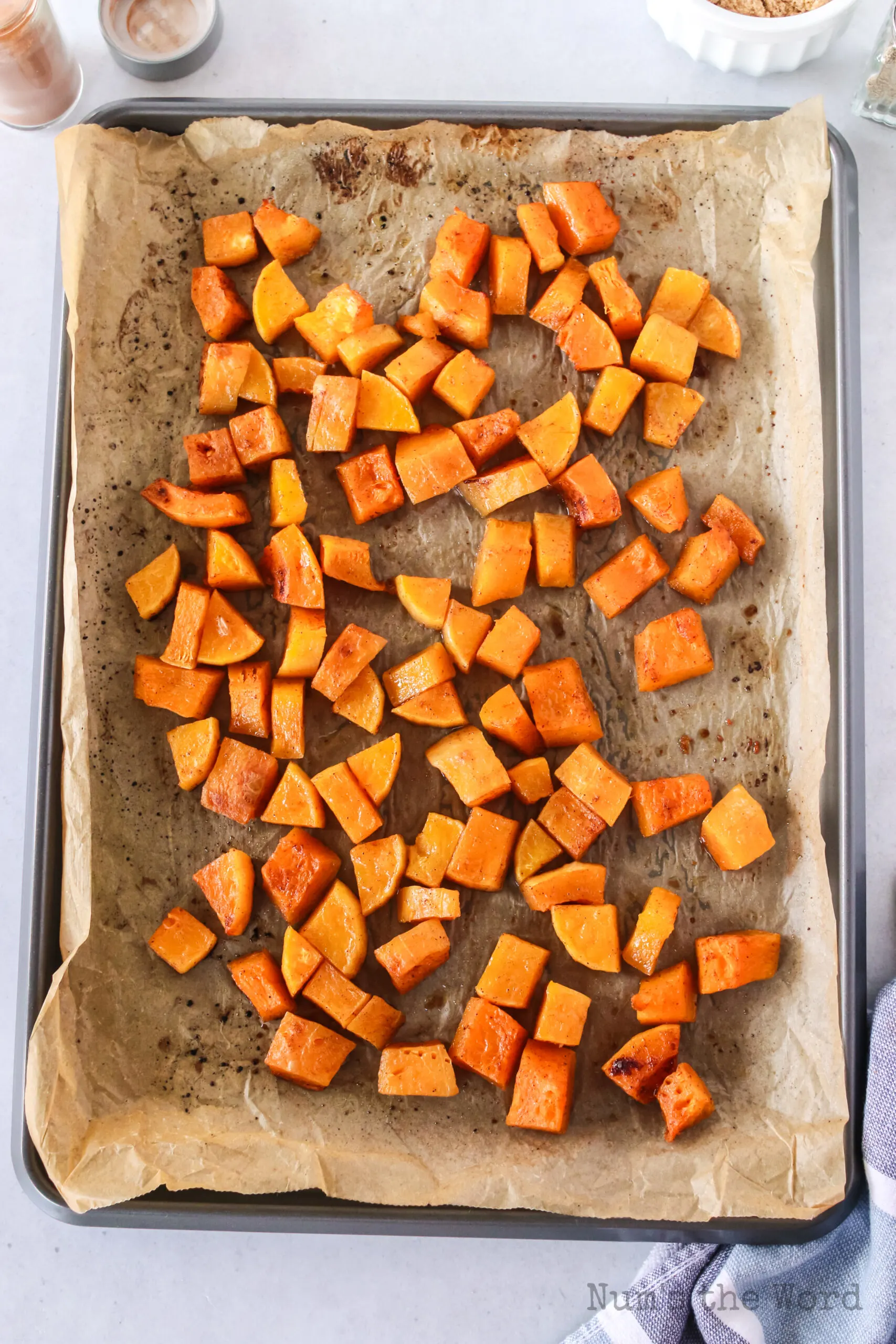 zoomed out image of squash on a cookie sheet.