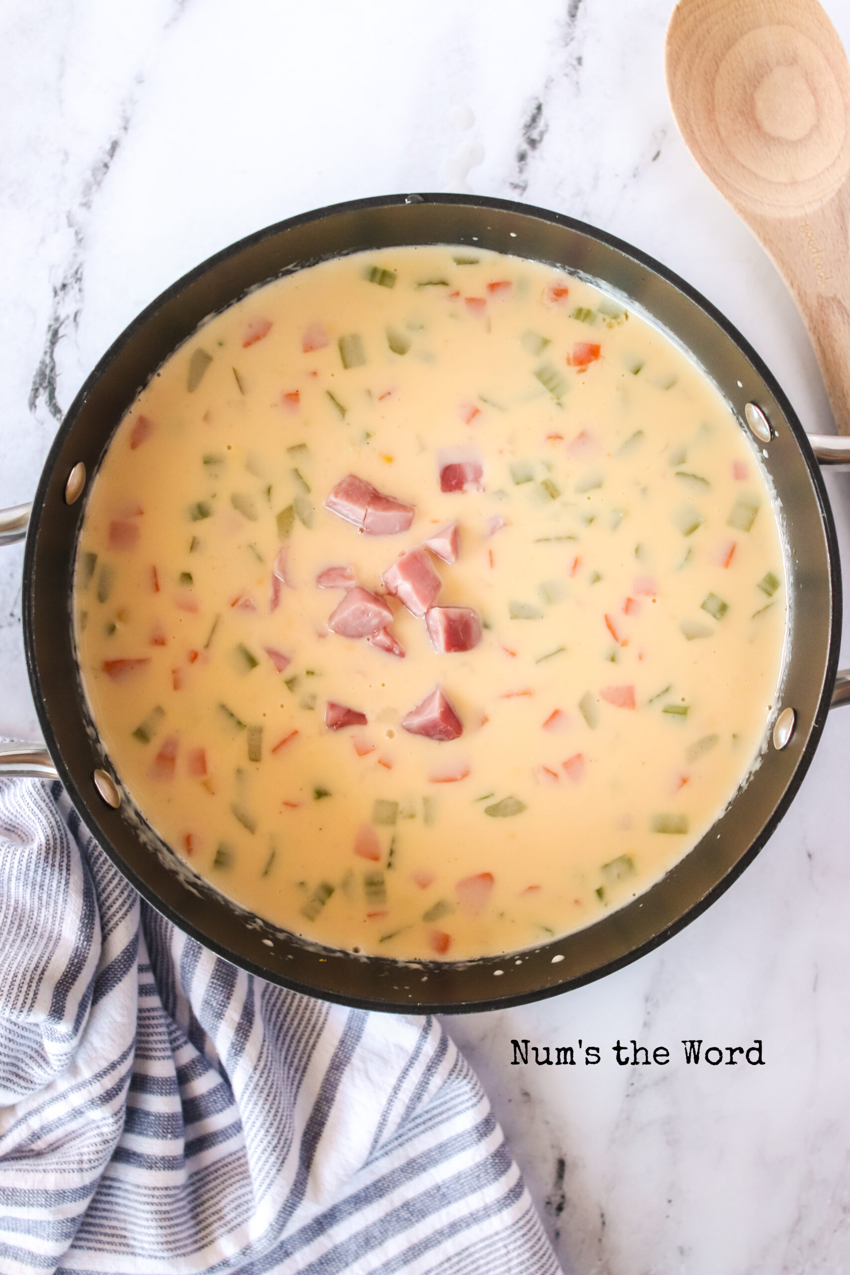 cheese sauce added to potato soup with ham added.