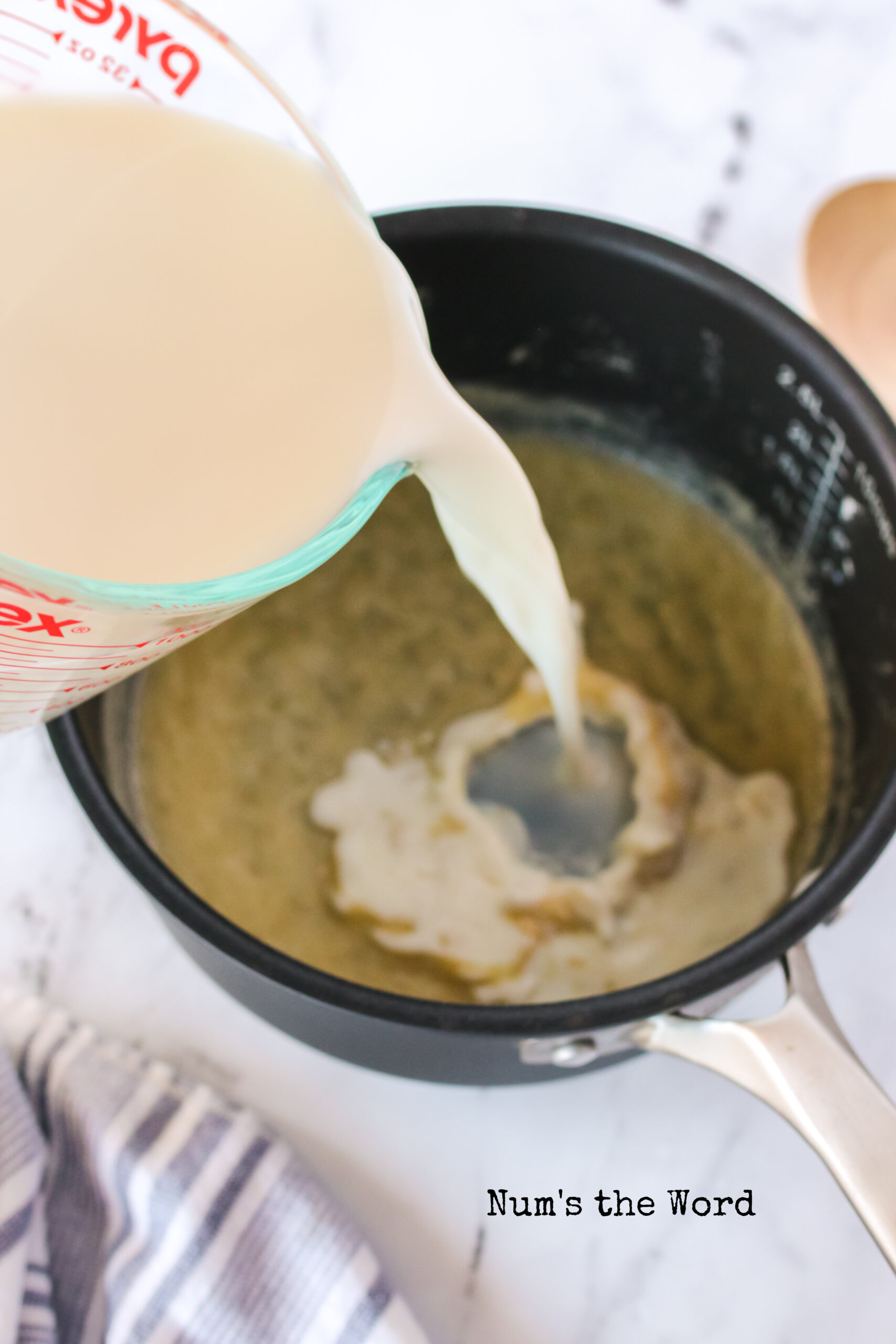 milk being added to flour mixture.