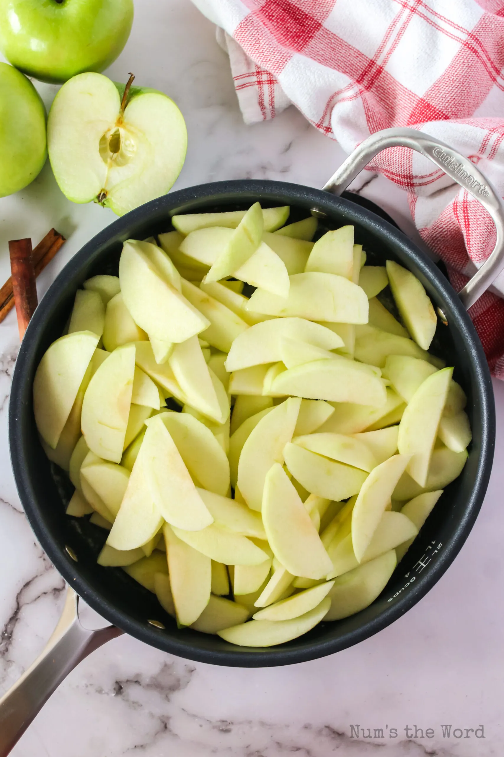 Sliced apples added to skillet