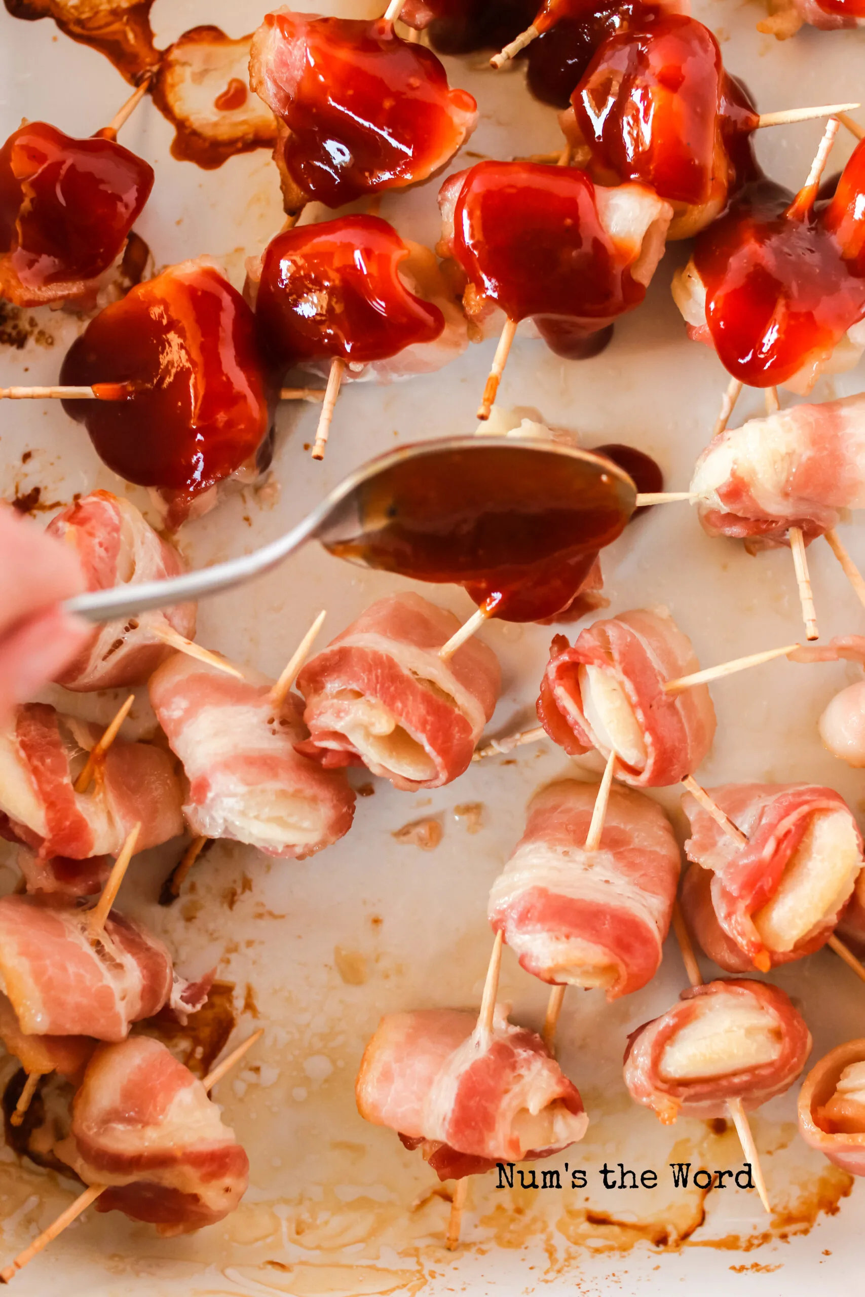 partially cooked water chestnuts in dish with sauce being drizzled over the top.