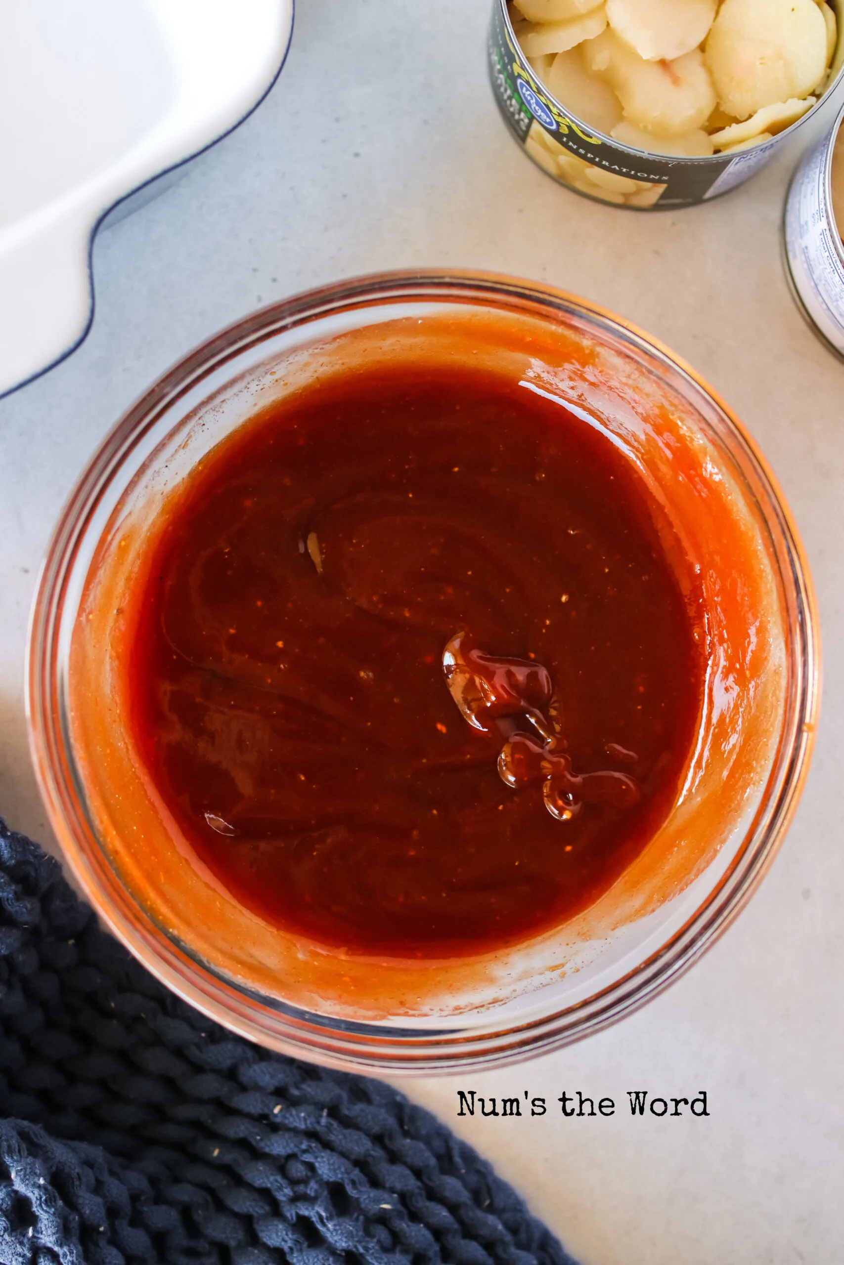 Sauce in a small bowl ready to be drizzles over bacon wrapped chesnuts