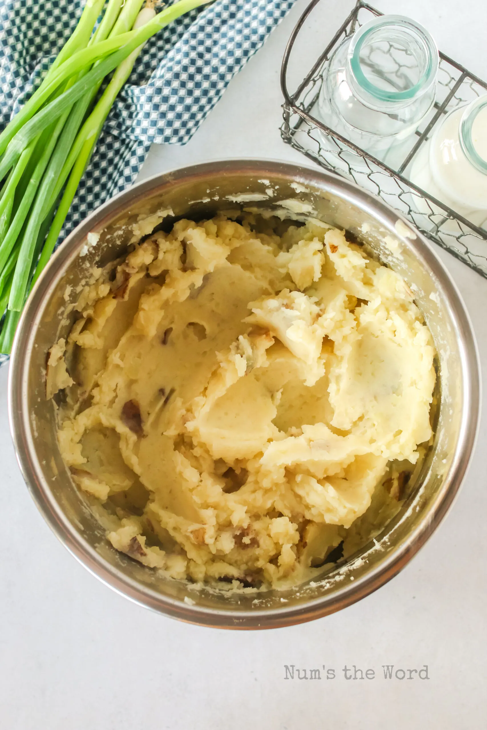 Potatoes mashed in the instant pot bowl. Milk added