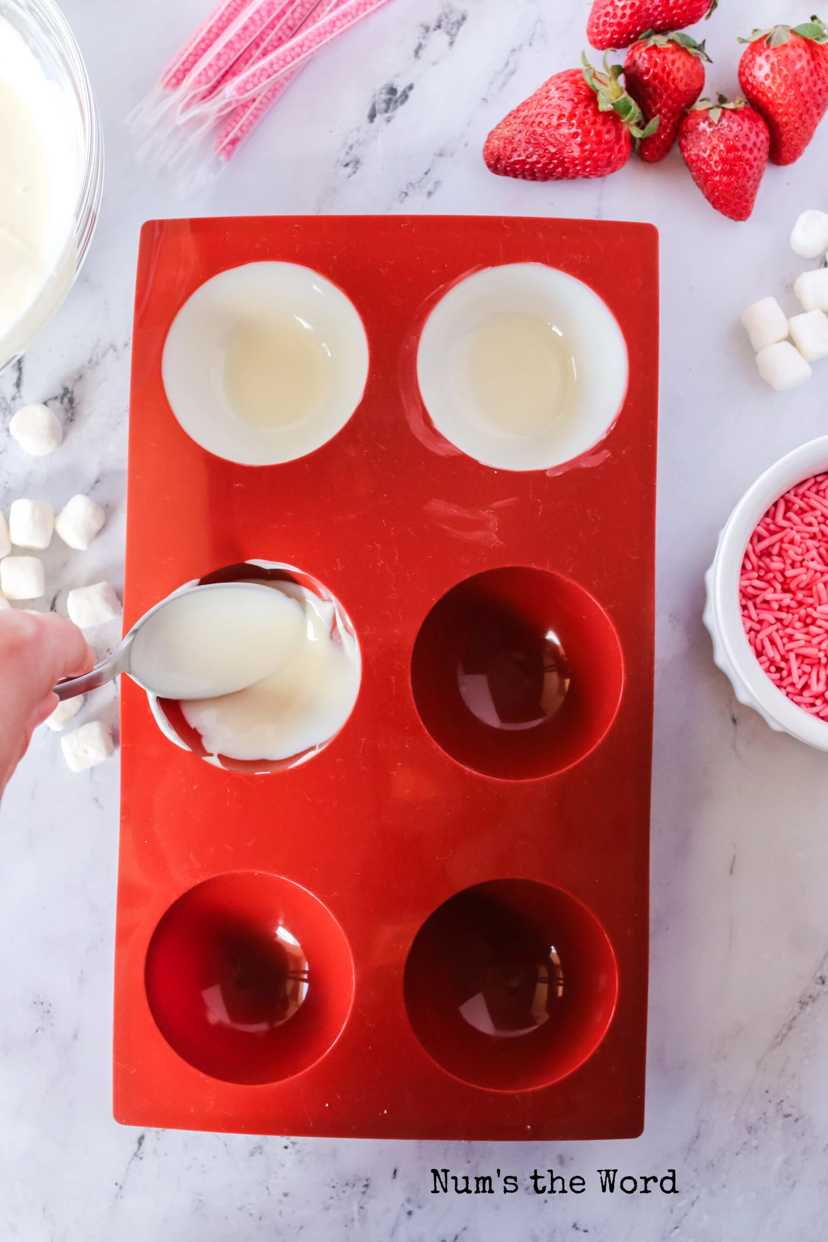 Spreading white chocolate in molds