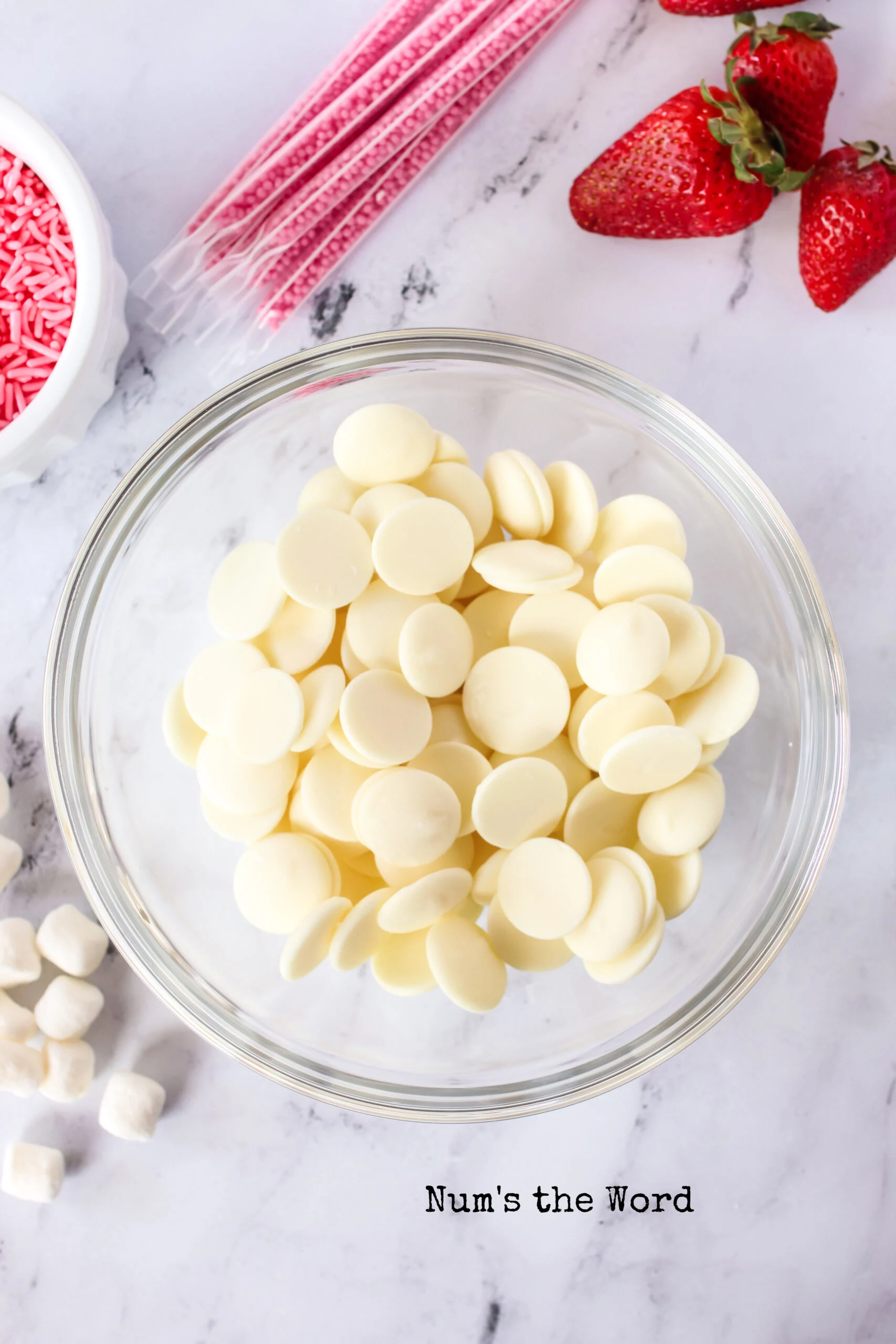 White chocolate melting wafers in a bowl, unmelted.