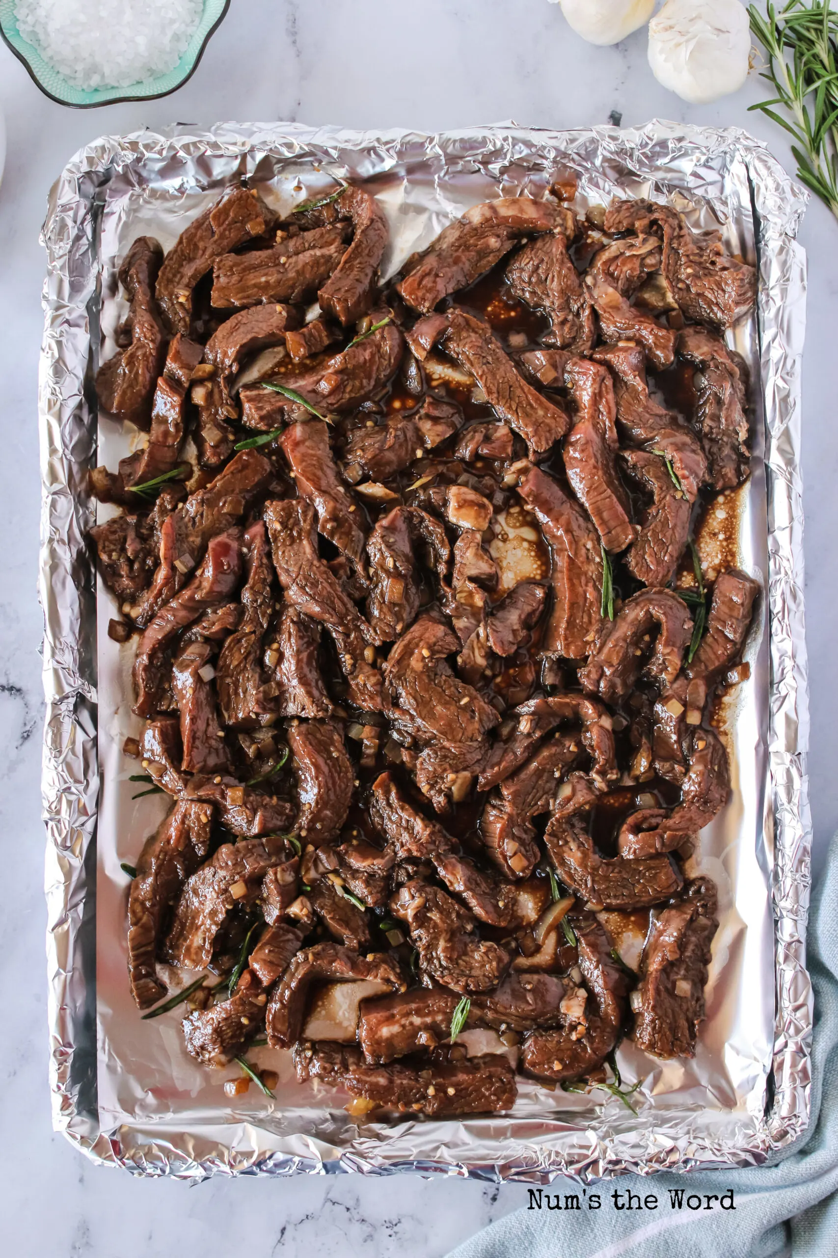 Flank steak placed on a lined cookie sheet, ready to be cooked.