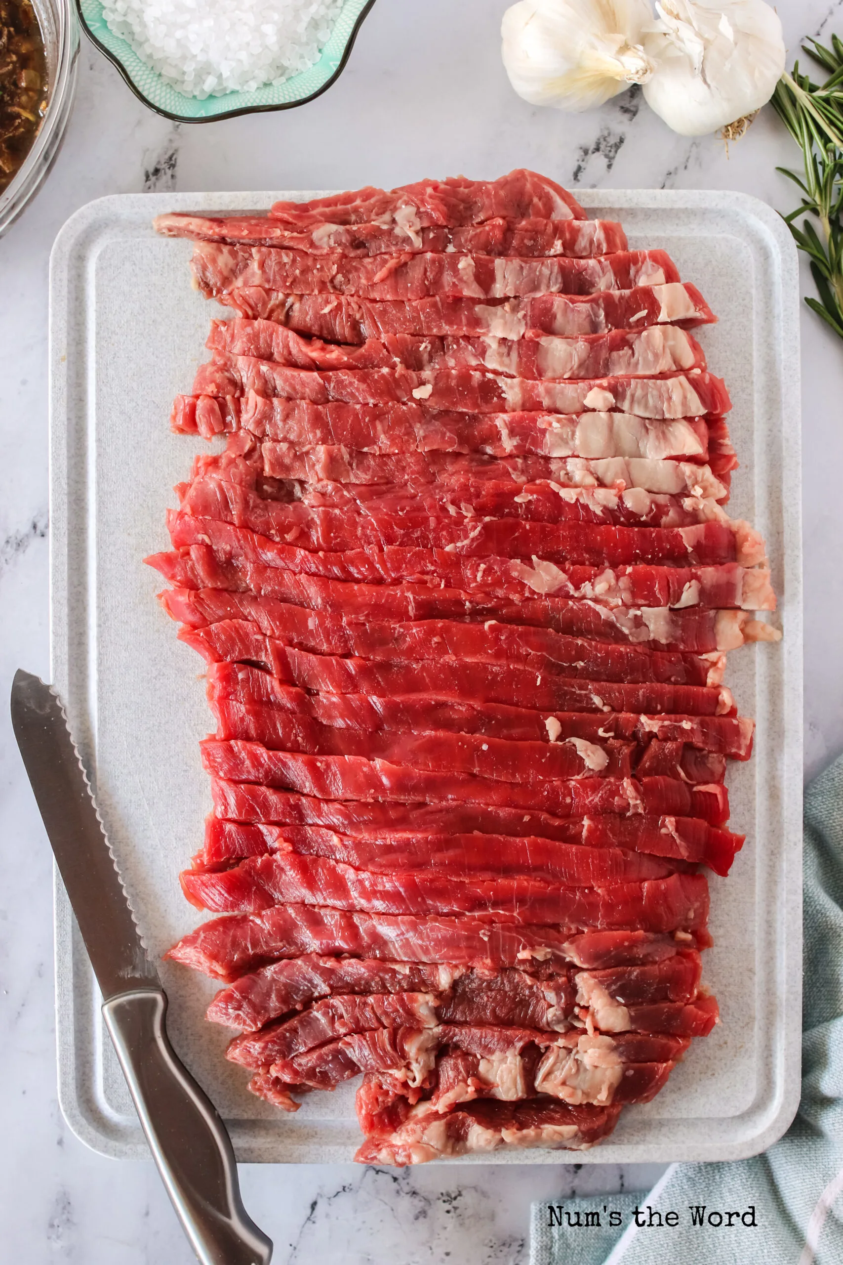 Flank steak thinly sliced and ready to marinade.