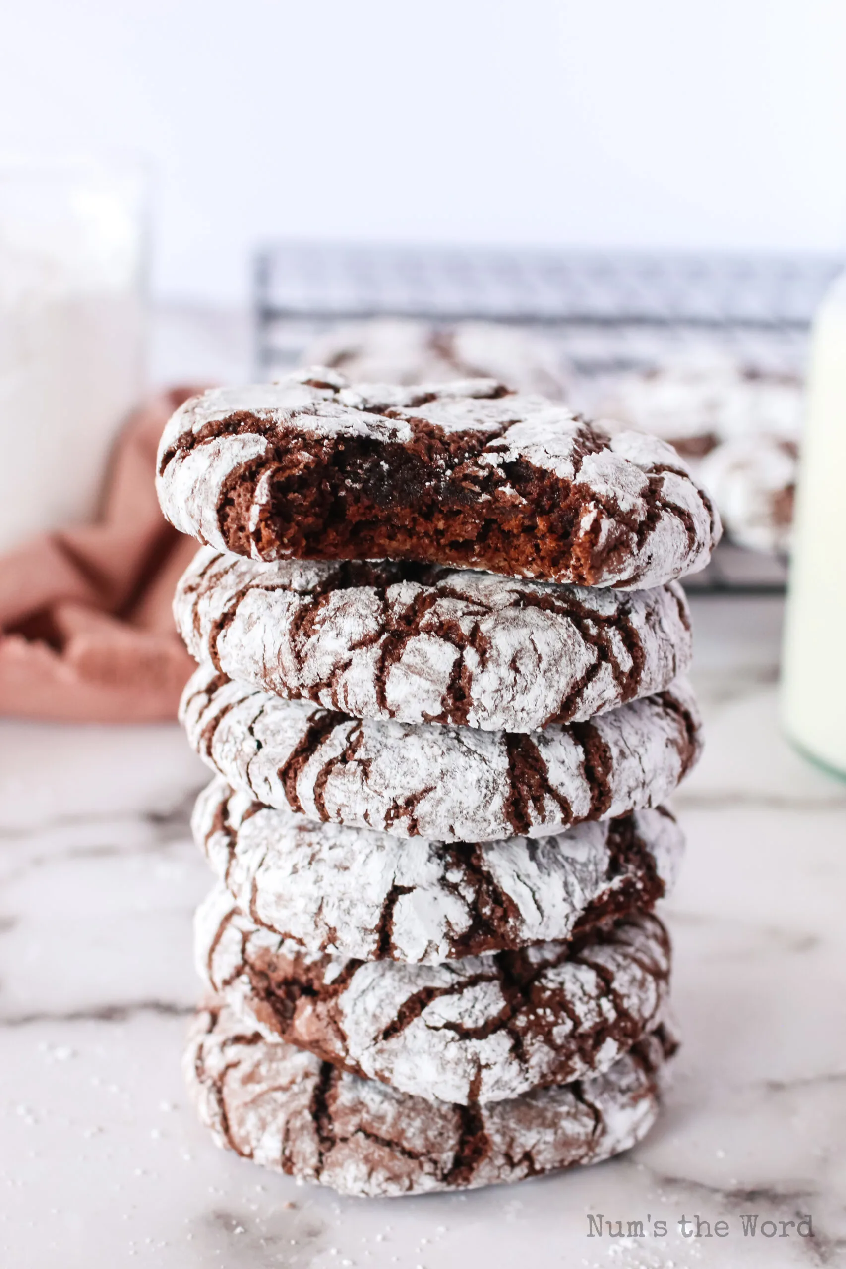 6 cookies stacked up with the top one missing a bite.