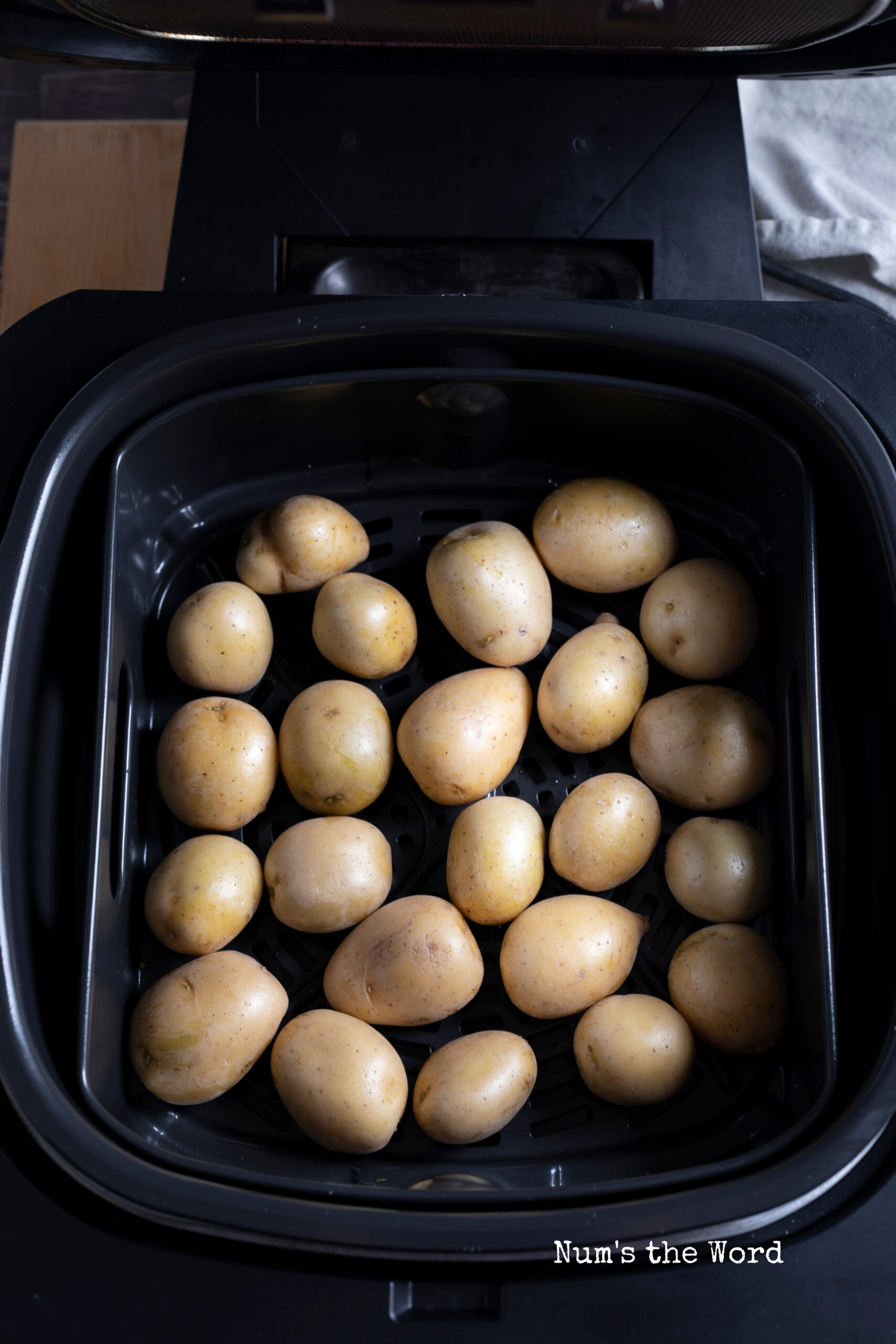 uncooked baby potatoes in air fryer ready to be cooked