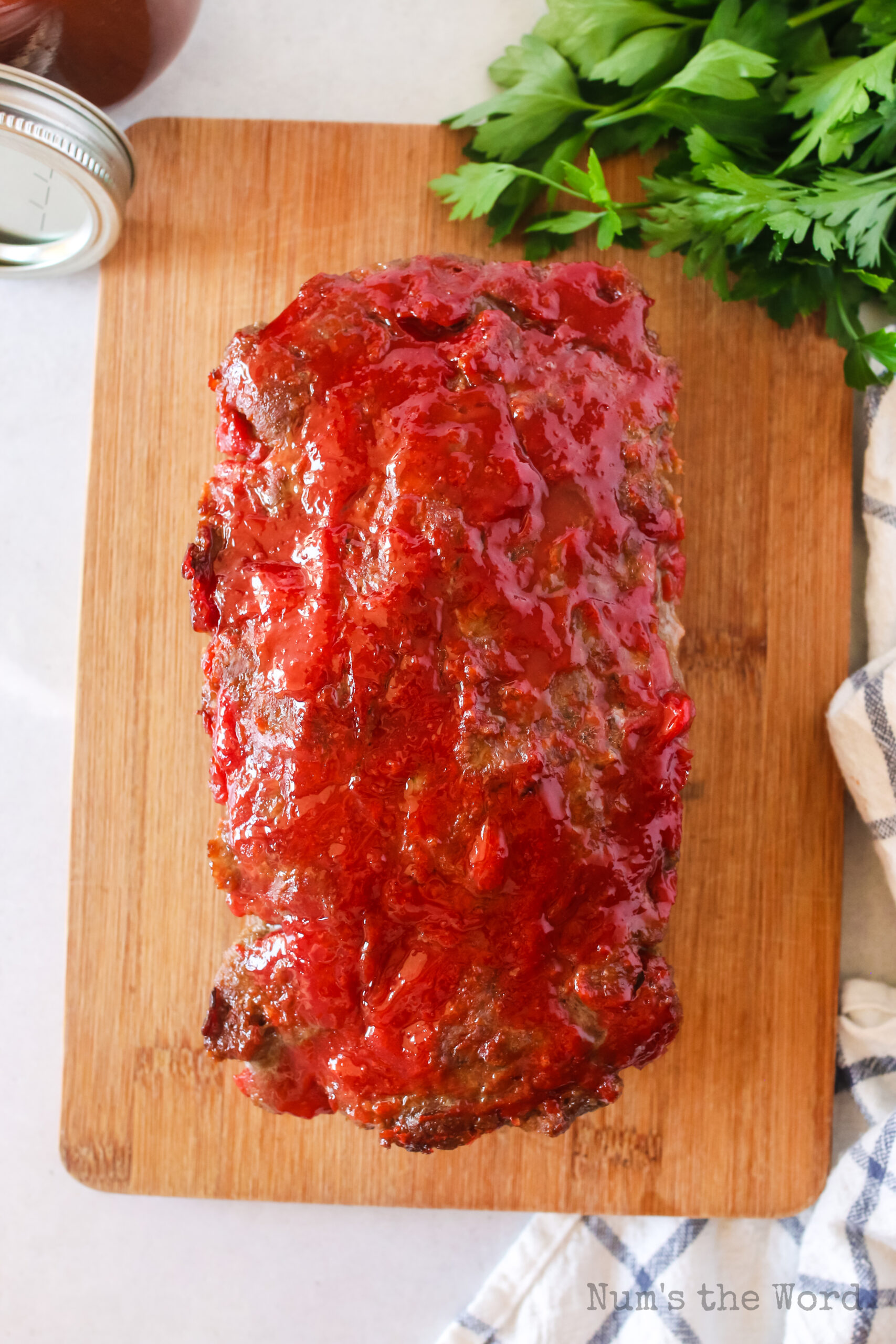 baked meatloaf on cutting board, ready to slice.