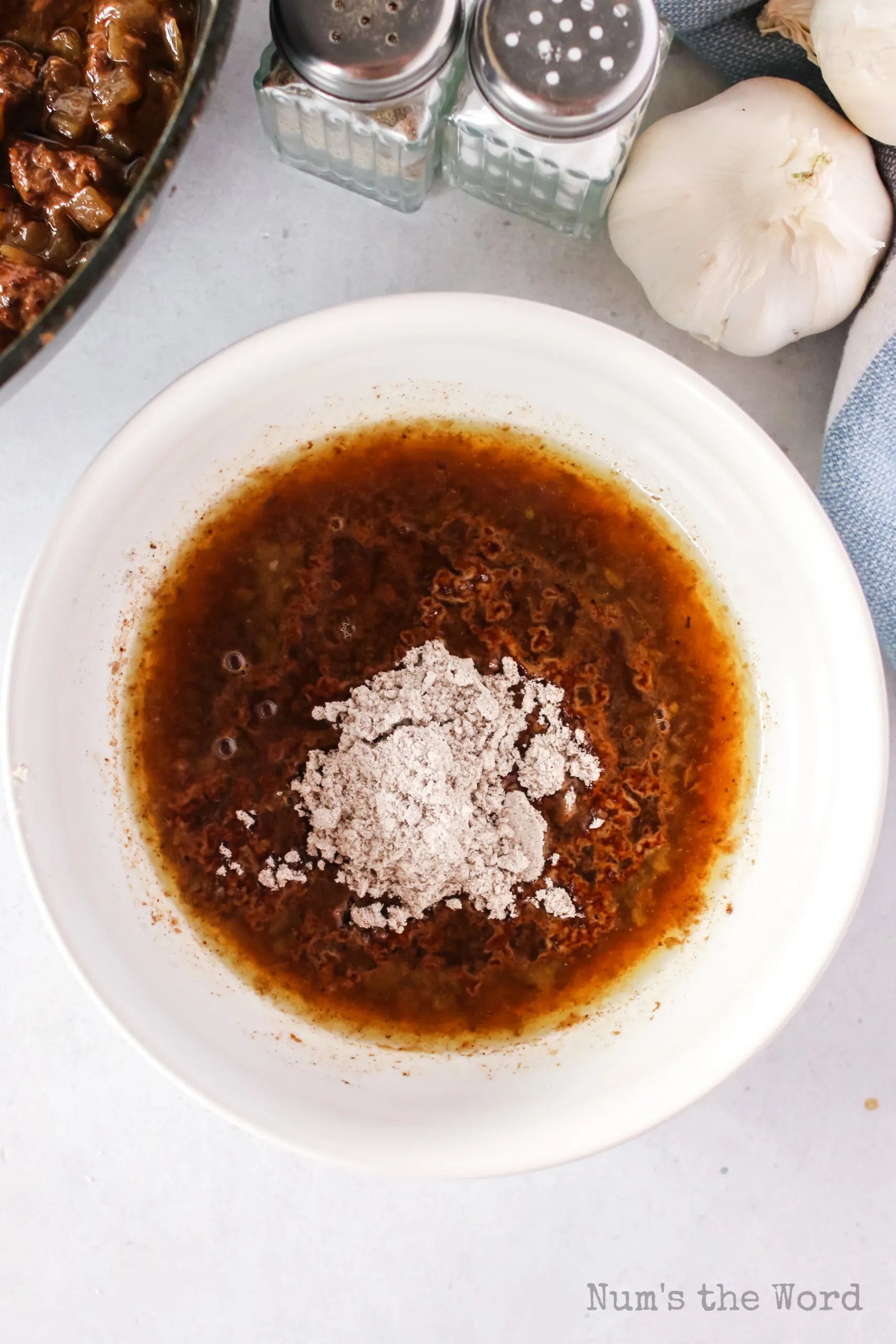 beef broth and gravy powder added to a bowl.