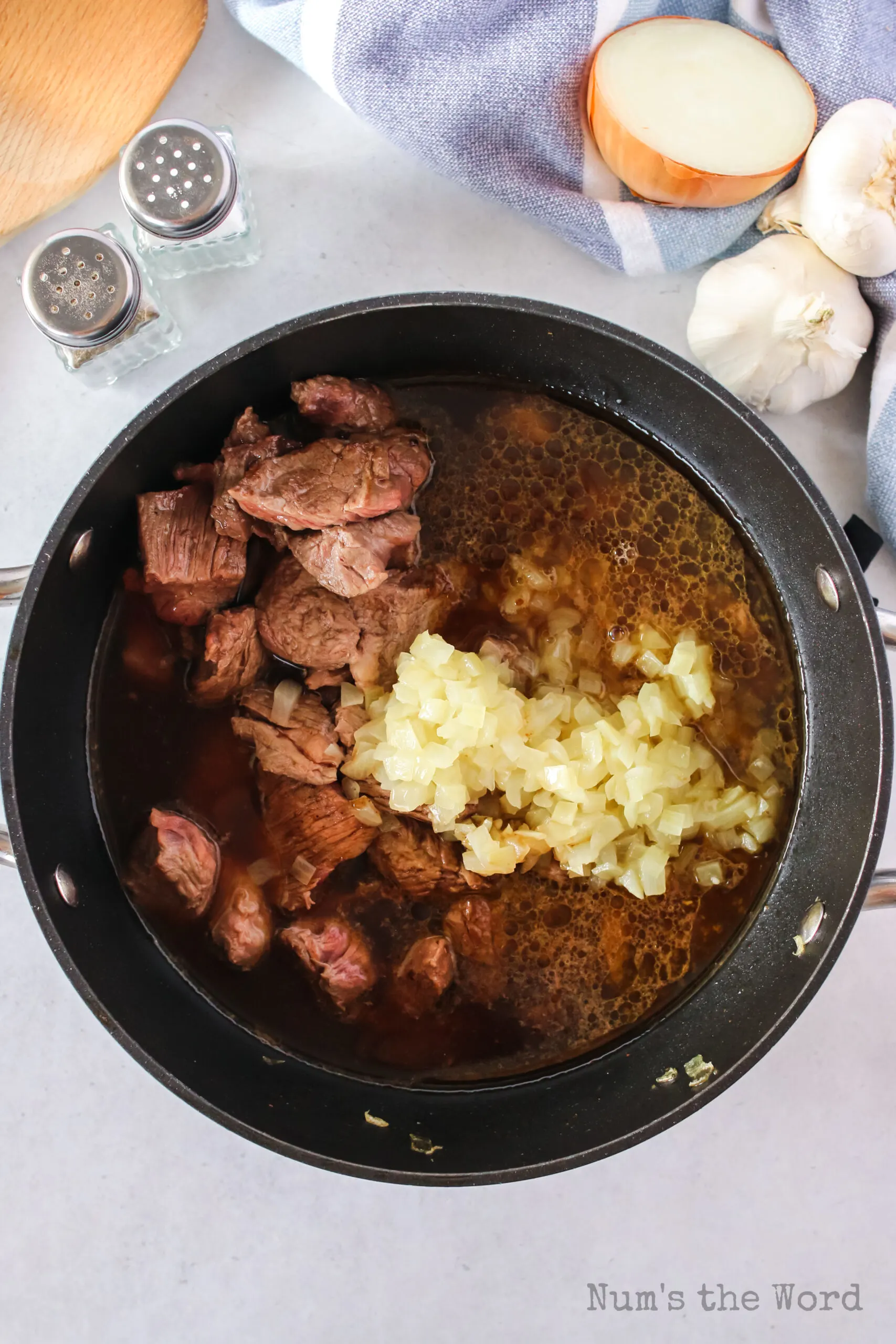 cooked stew beef with onions added back to pot. Broth, soy sauce, worcestershire sauce, salt and pepper added also.