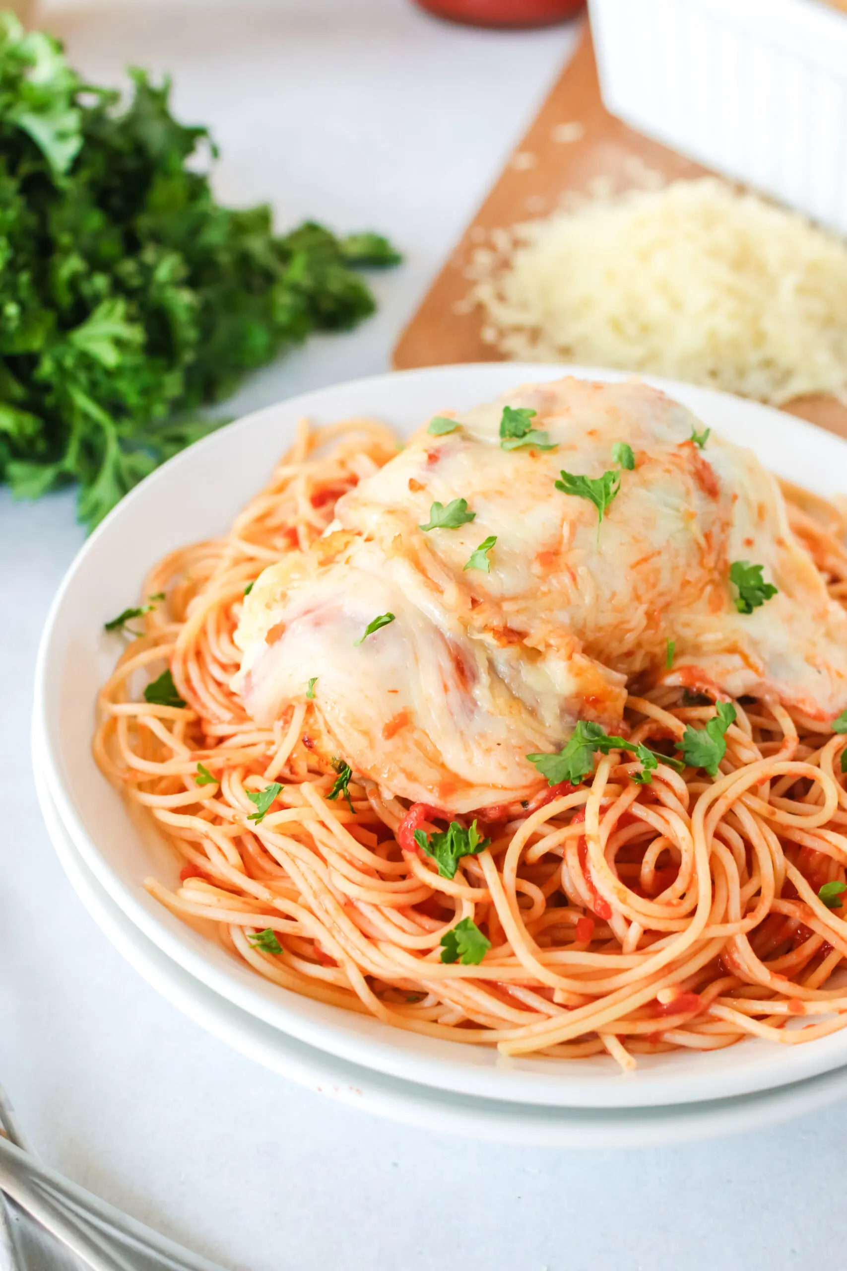 side view of chicken on top of pasta