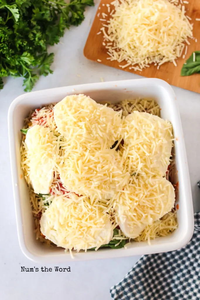 Parmesan cheese placed on top of mozzarella cheese