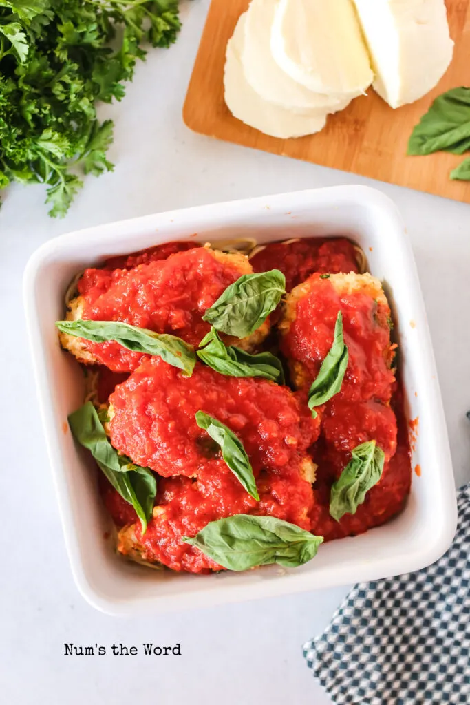 fresh basil placed on top of chicken