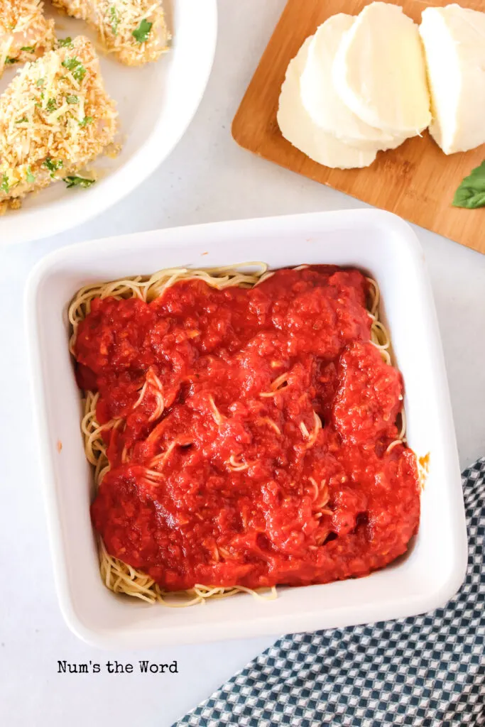 Marinara sauce poured over angel hair pasta