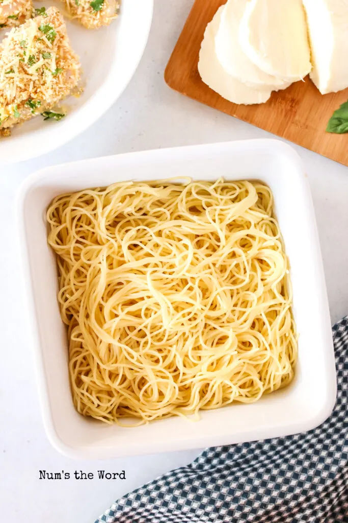 Plain pasta in the bottom of a square baking dish