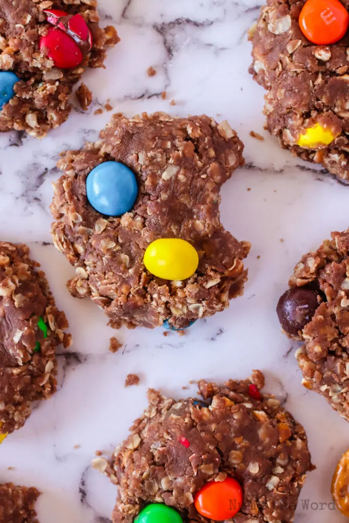 close up of cookies on counter. One cookie has a bite removed.