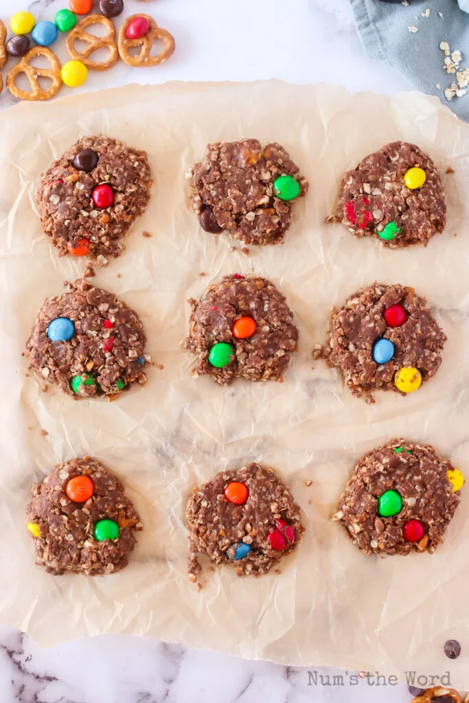 cookies scooped out onto parchment paper to cool