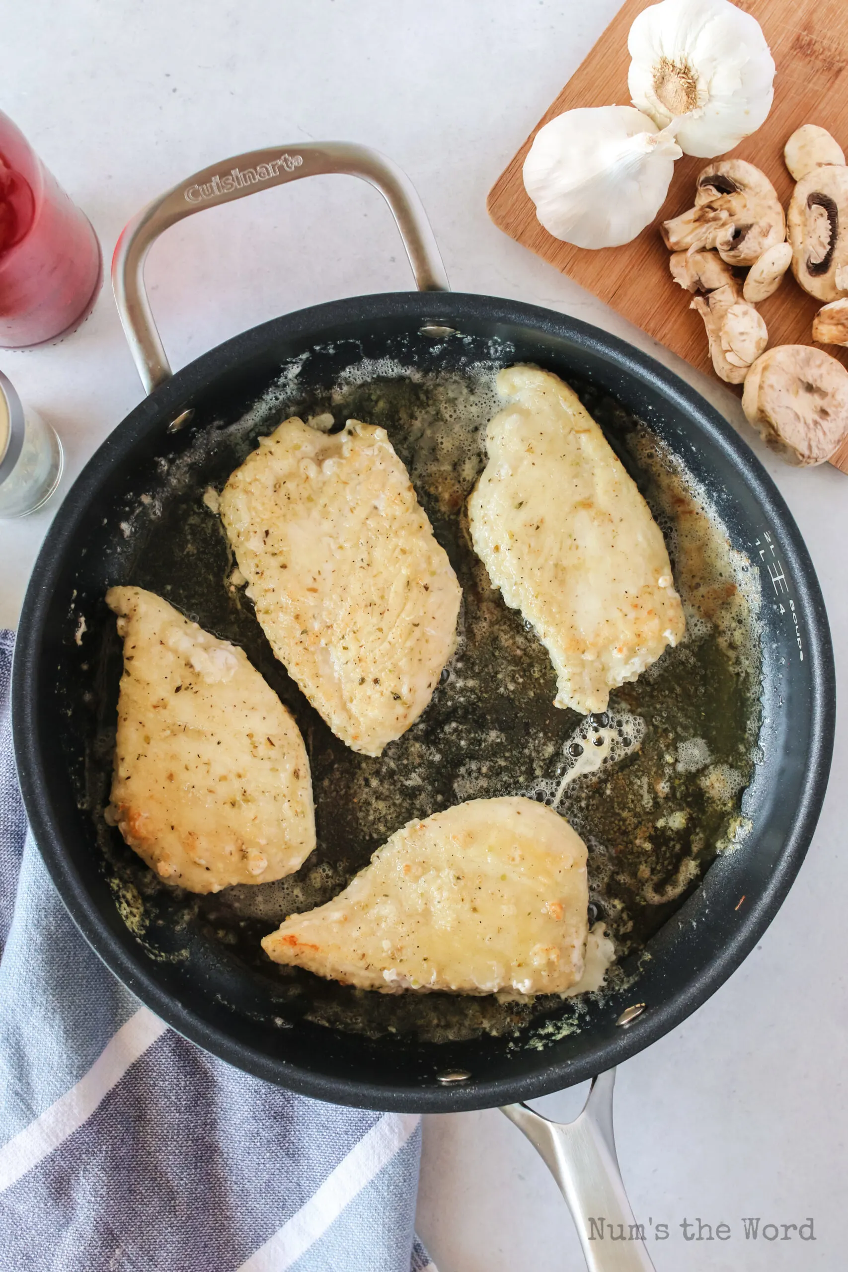 chicken cooking in butter in a skillet