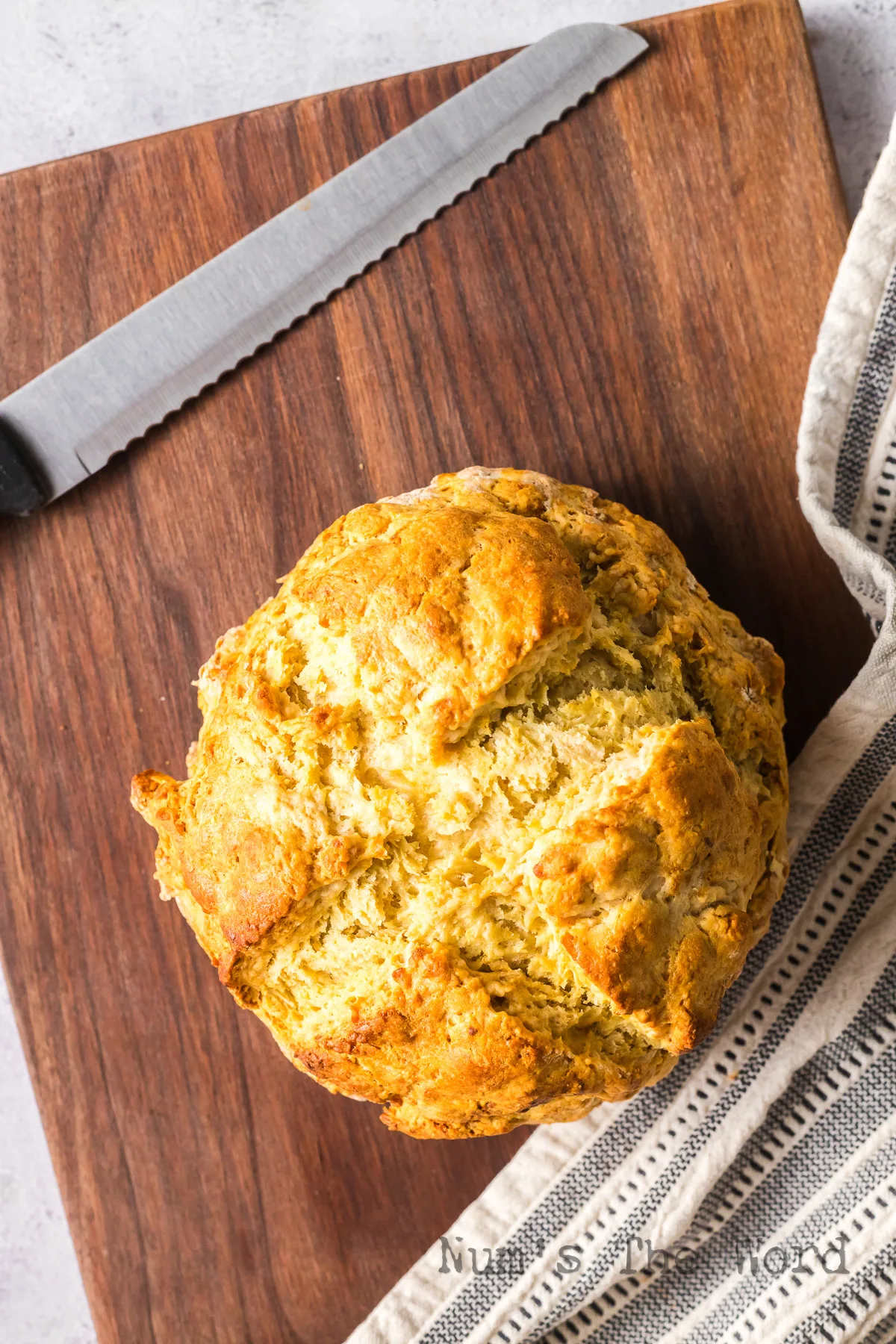 top view looking down at Irish Soda Bread on cutting board fresh from oven.