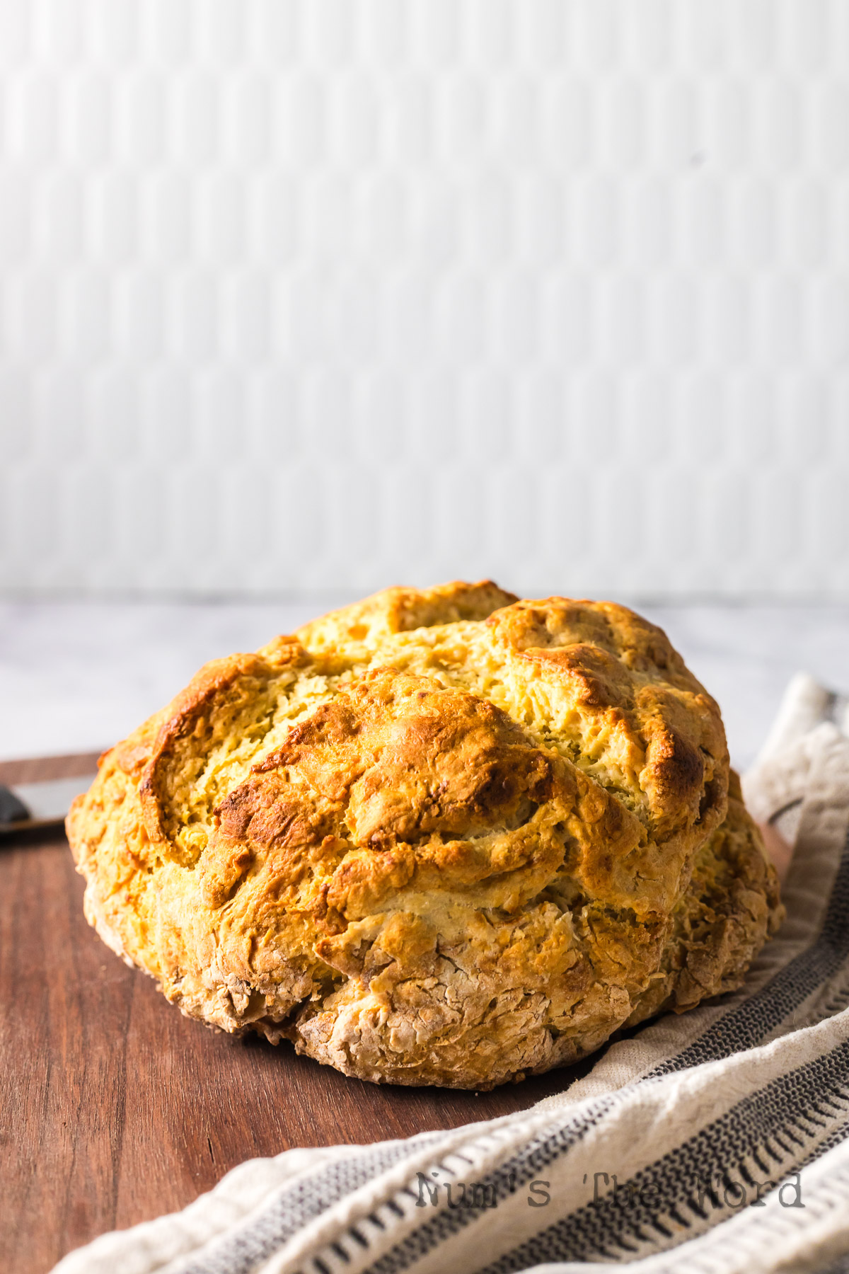 side view of baked bread on cutting board.