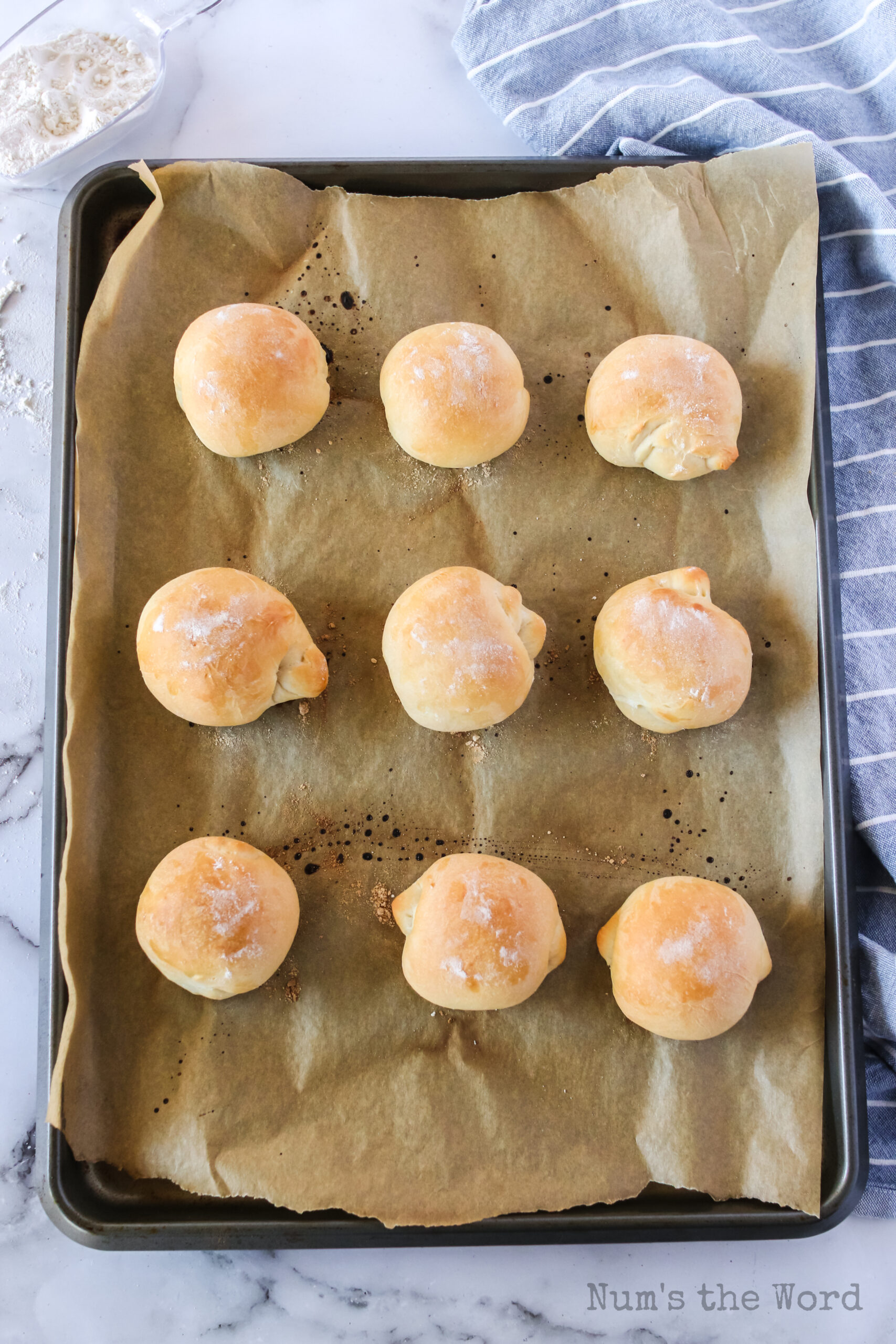 baked sandwich rolls on cookie sheet.