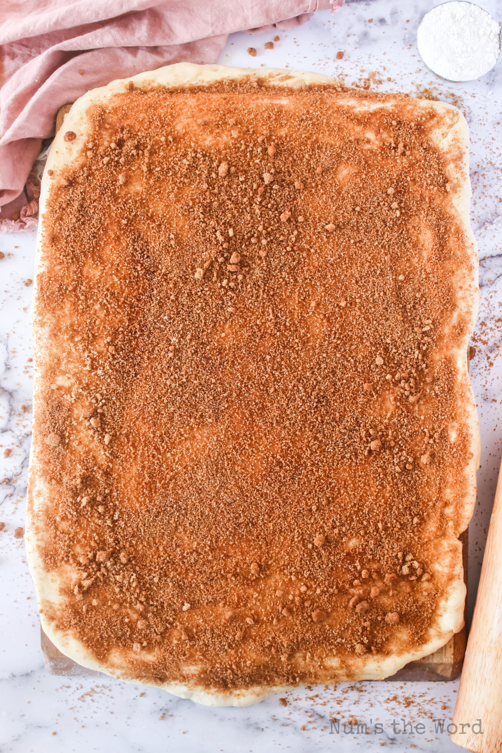 cinnamon sugar spread all over buttered dough