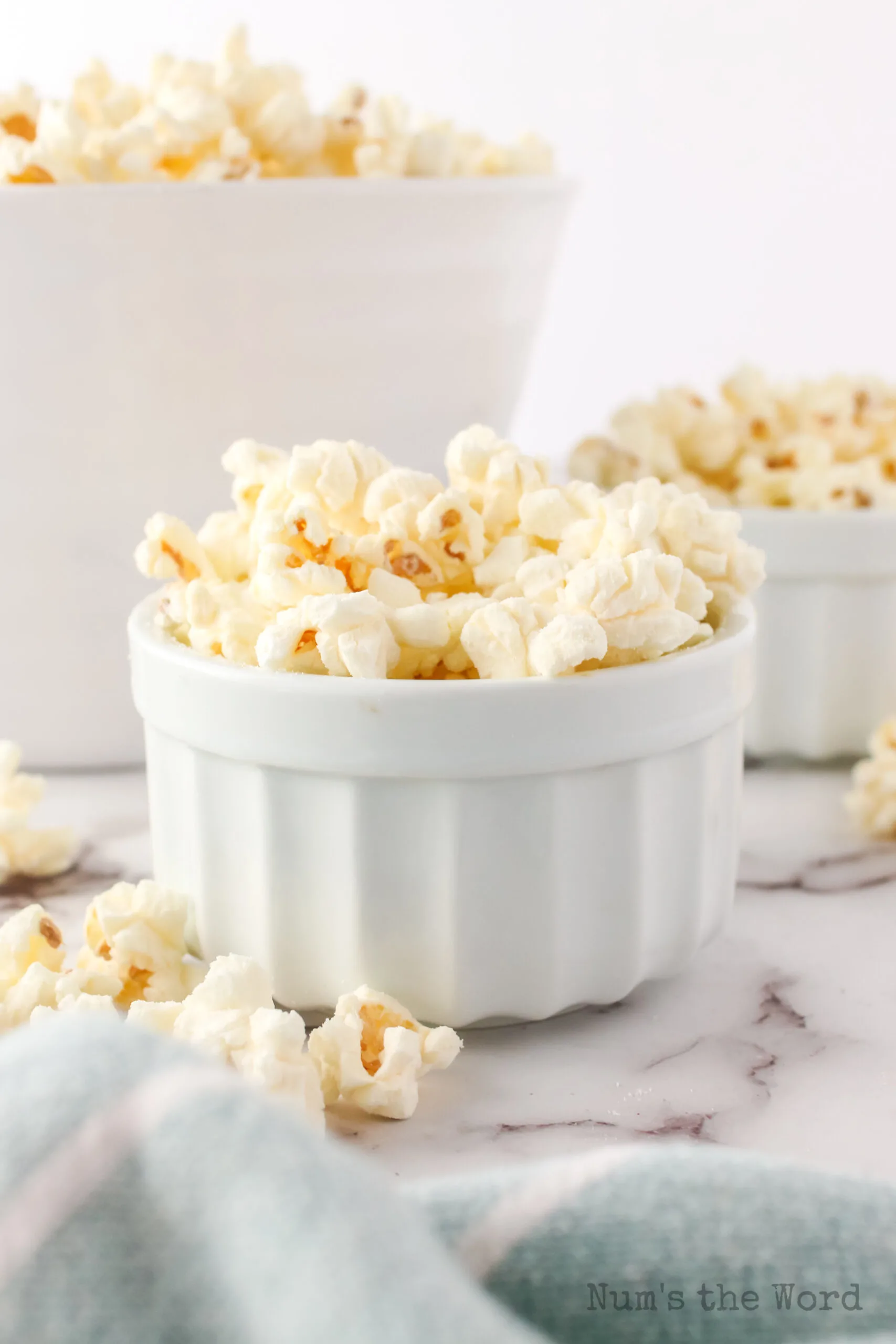 side view of small bowl of popcorn with another in the background