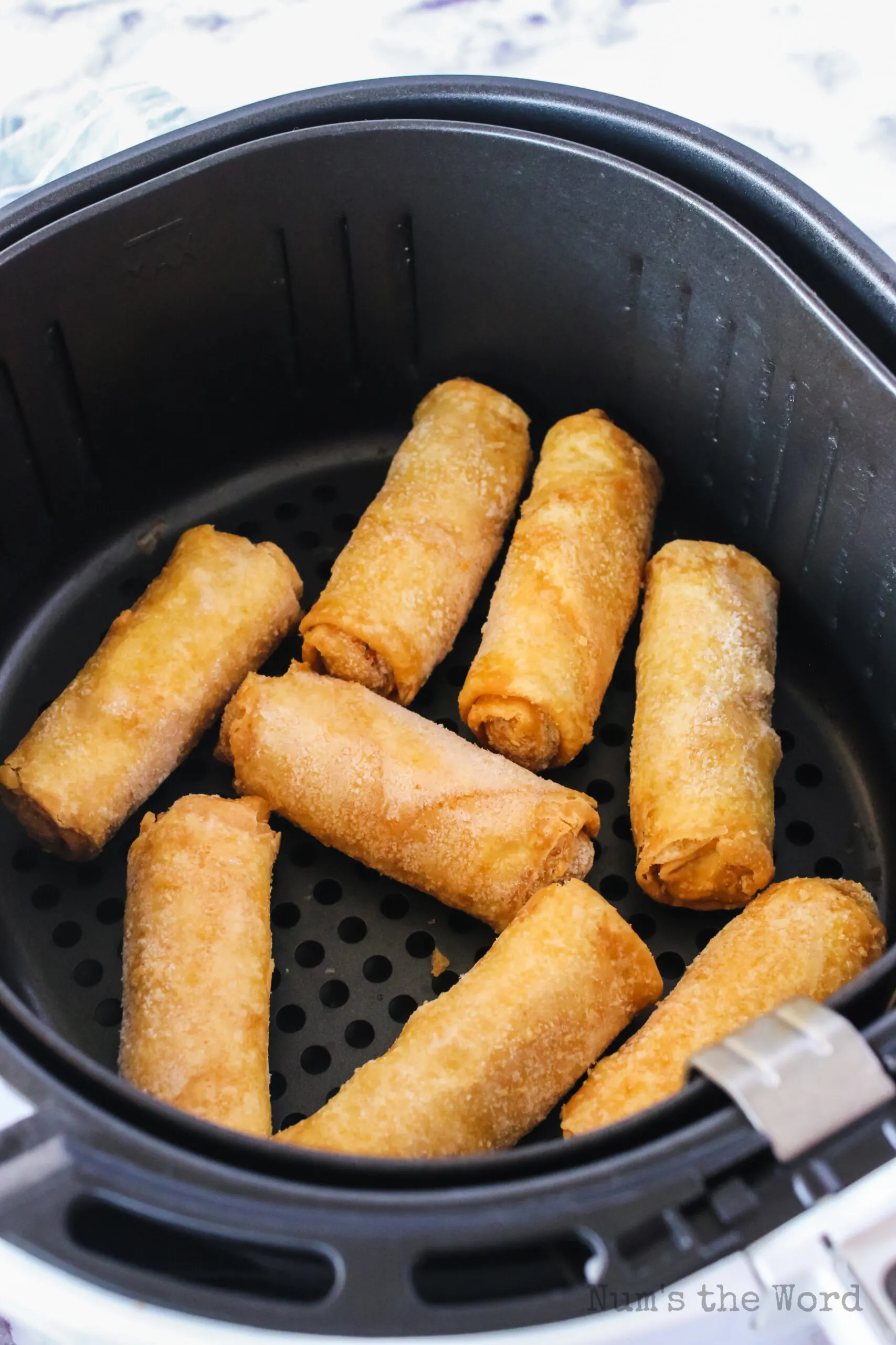 Frozen egg rolls in air fryer basket