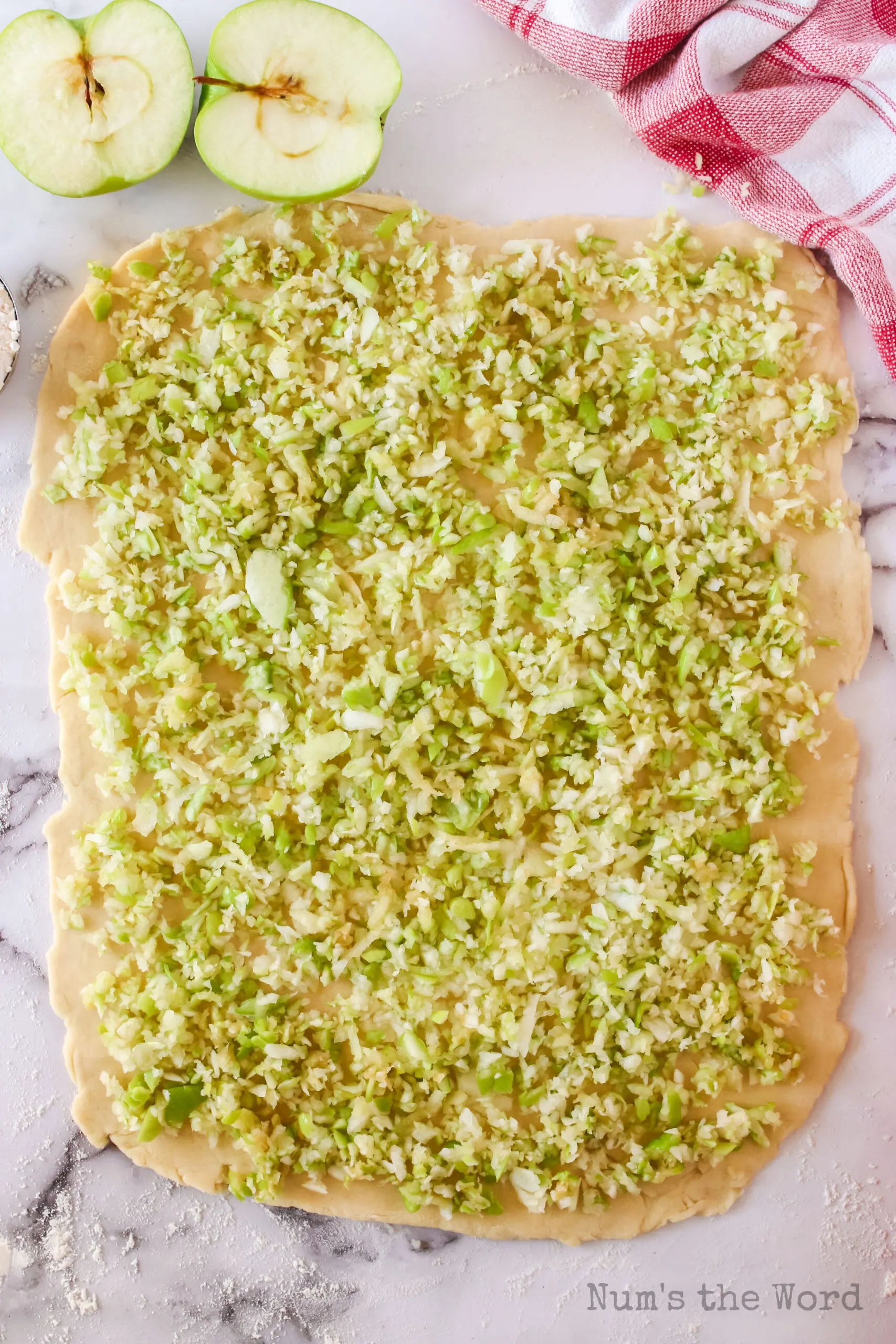 Shredded apples on pastry dough