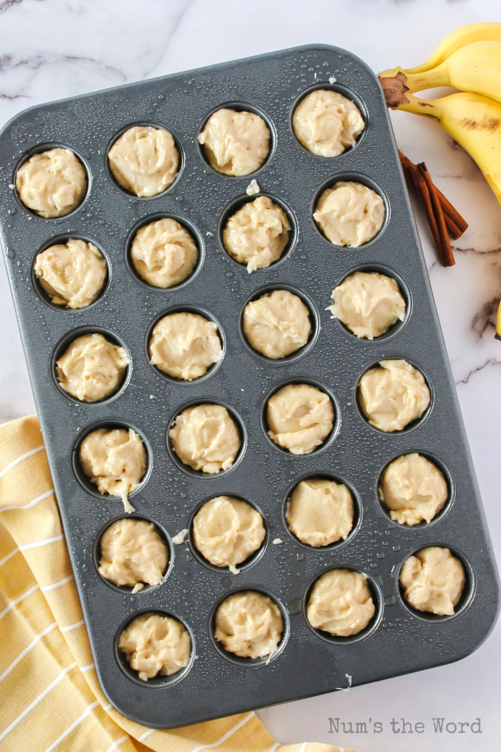 muffin mix placed into a muffin pan.