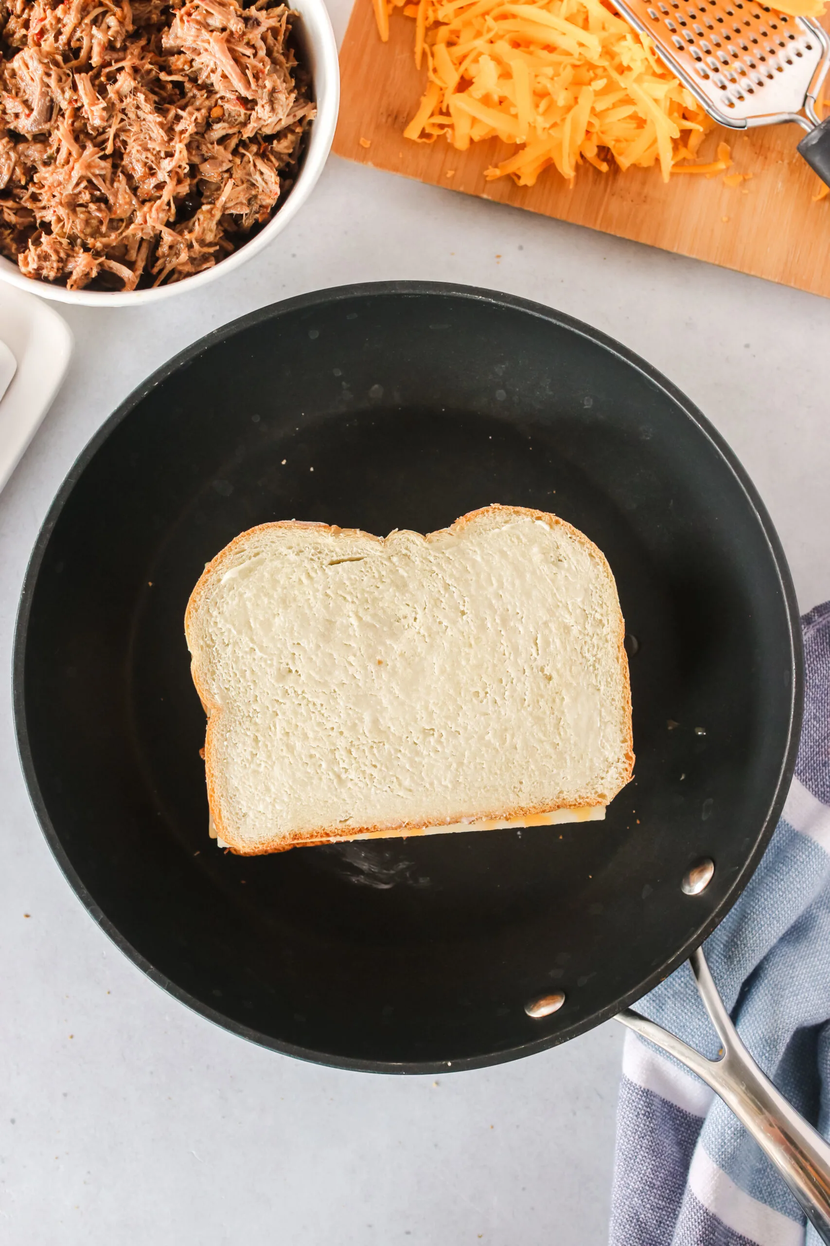 top slice of bread placed on top of cheese