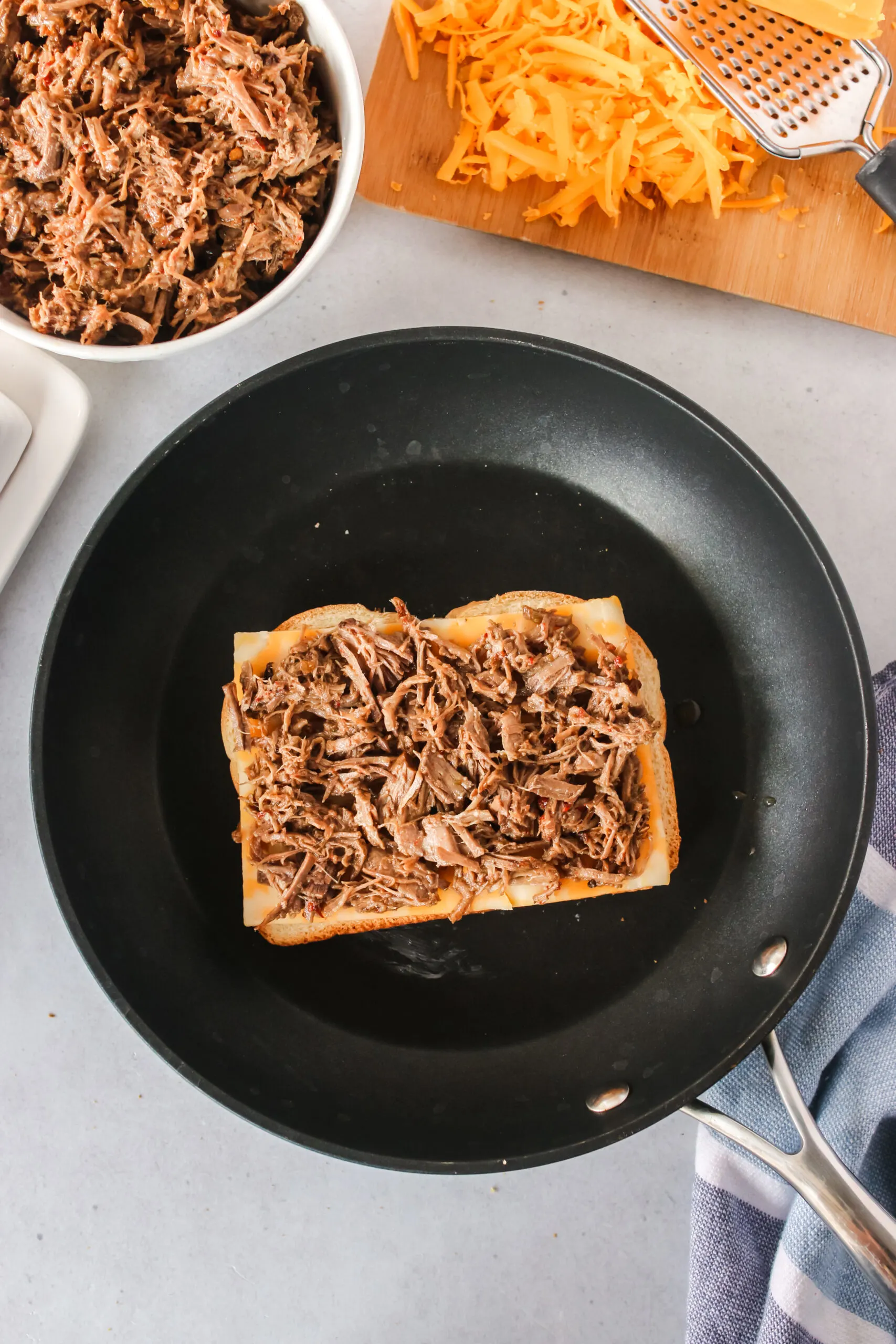 shredded beef placed on top of cheese