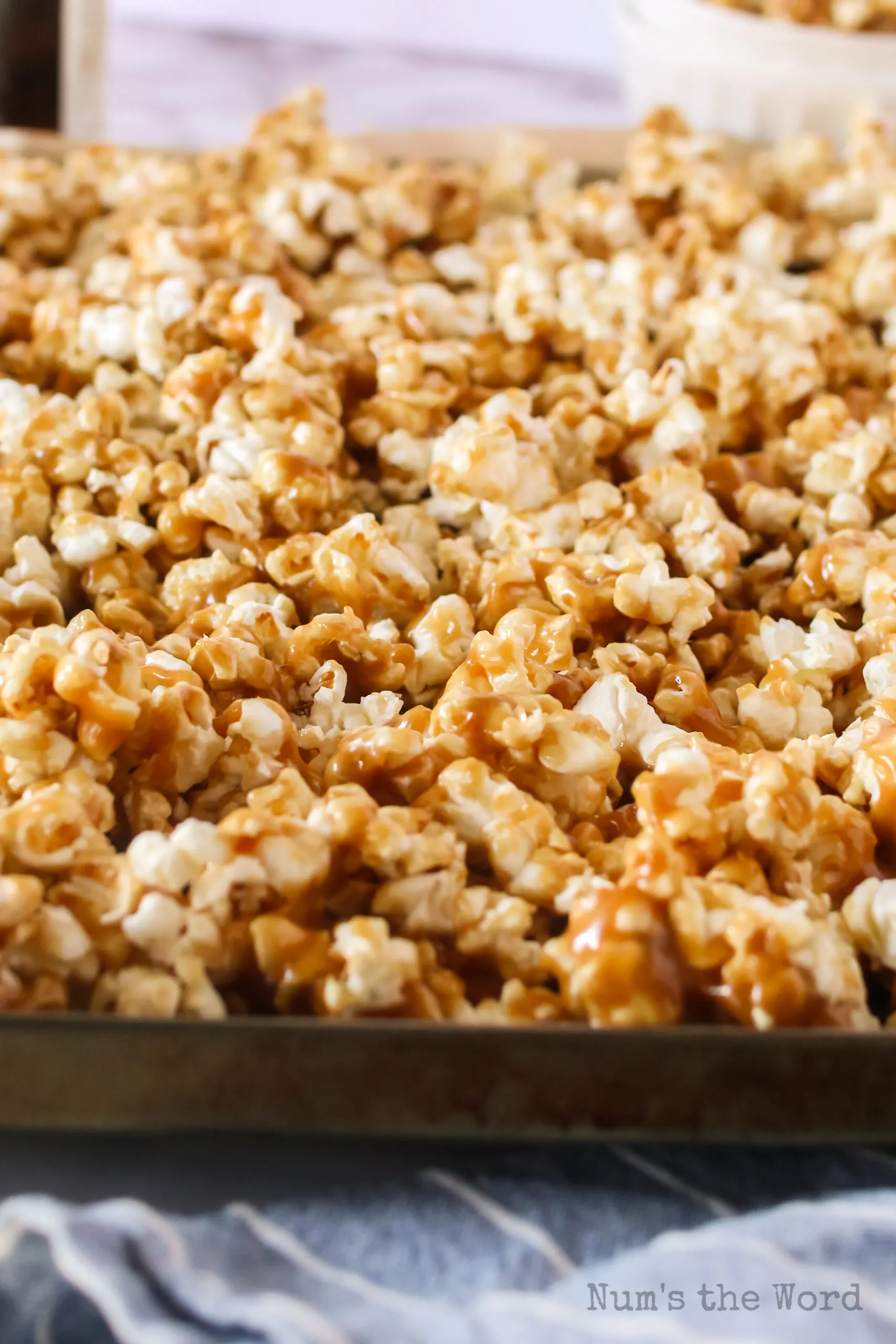 side view of caramel corn on cookie sheet.