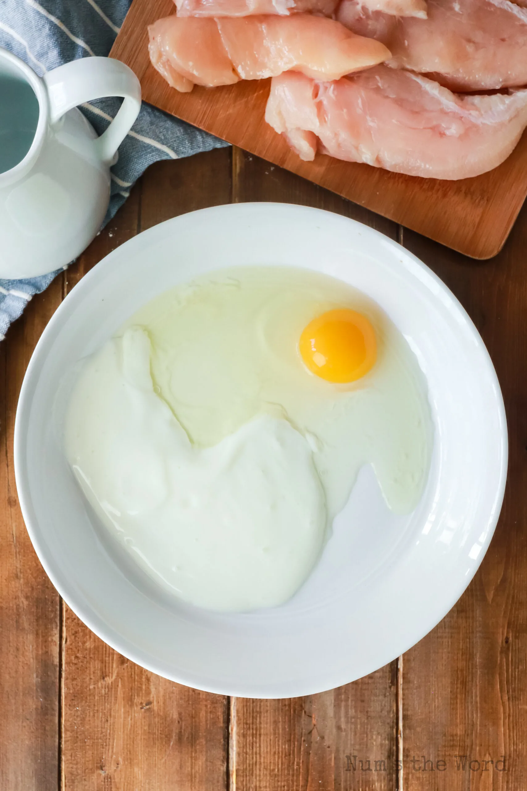 egg and milk in a bowl, unmixed