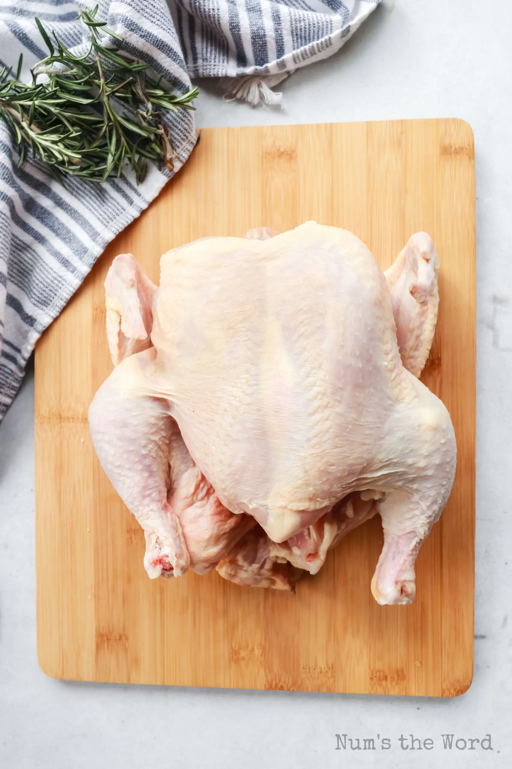 whole chicken on a cutting board.