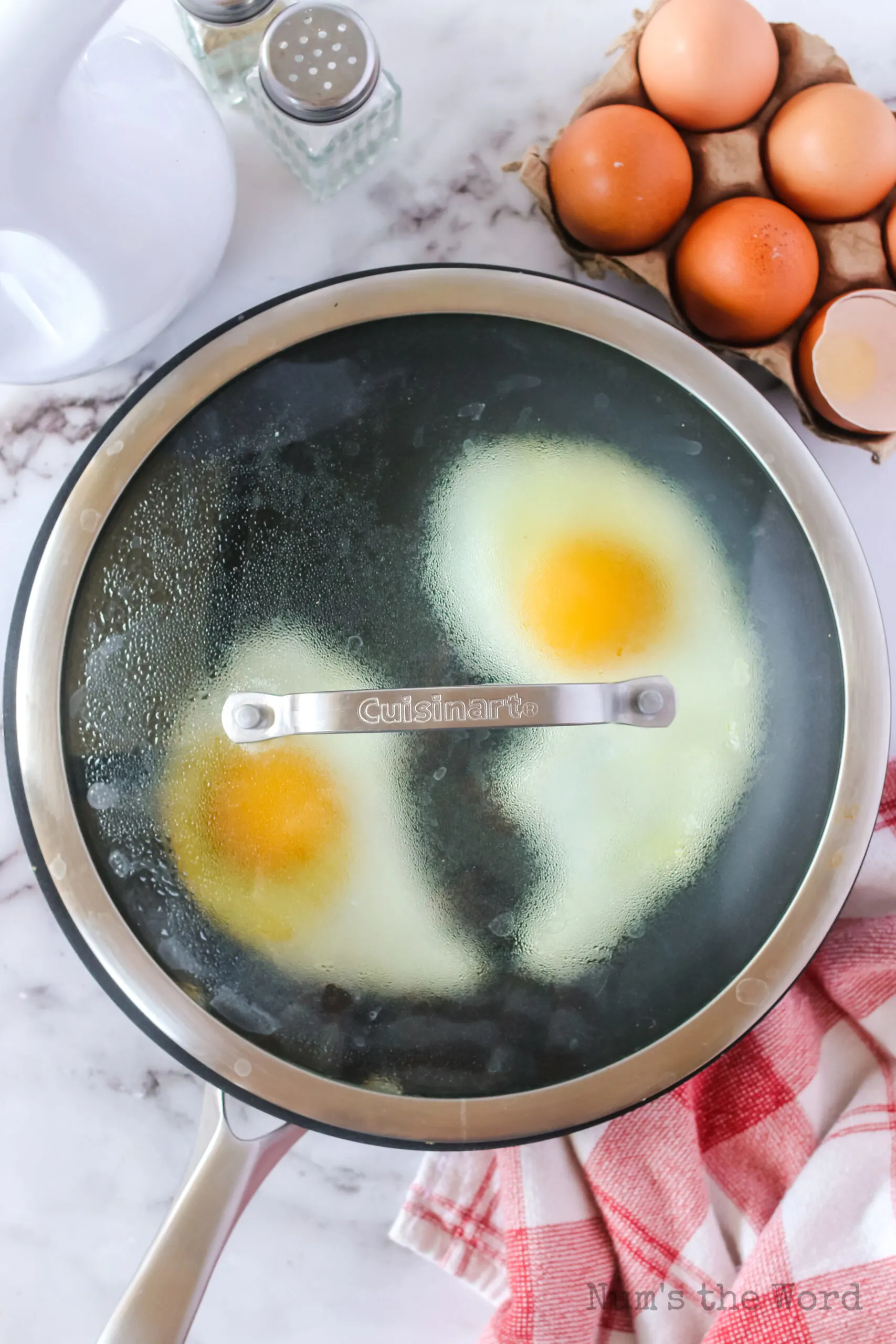 eggs in a pan with a lid on to steam eggs