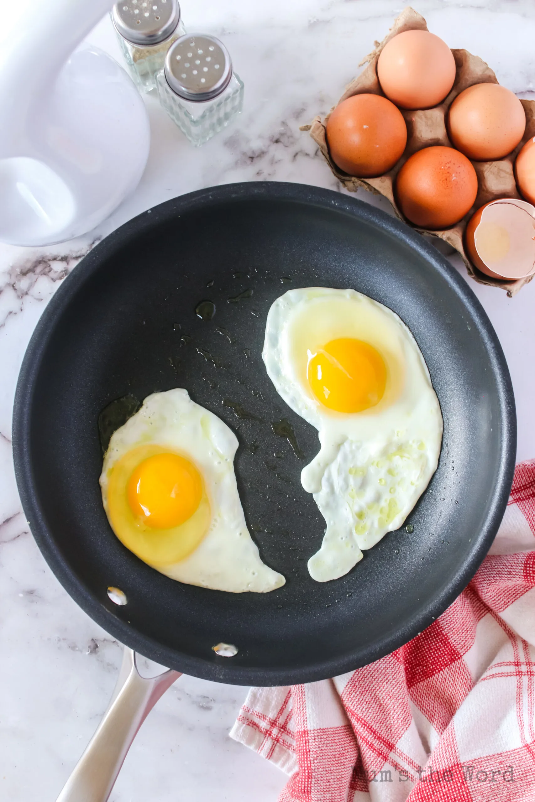 raw eggs placed in skillet, ready to cook